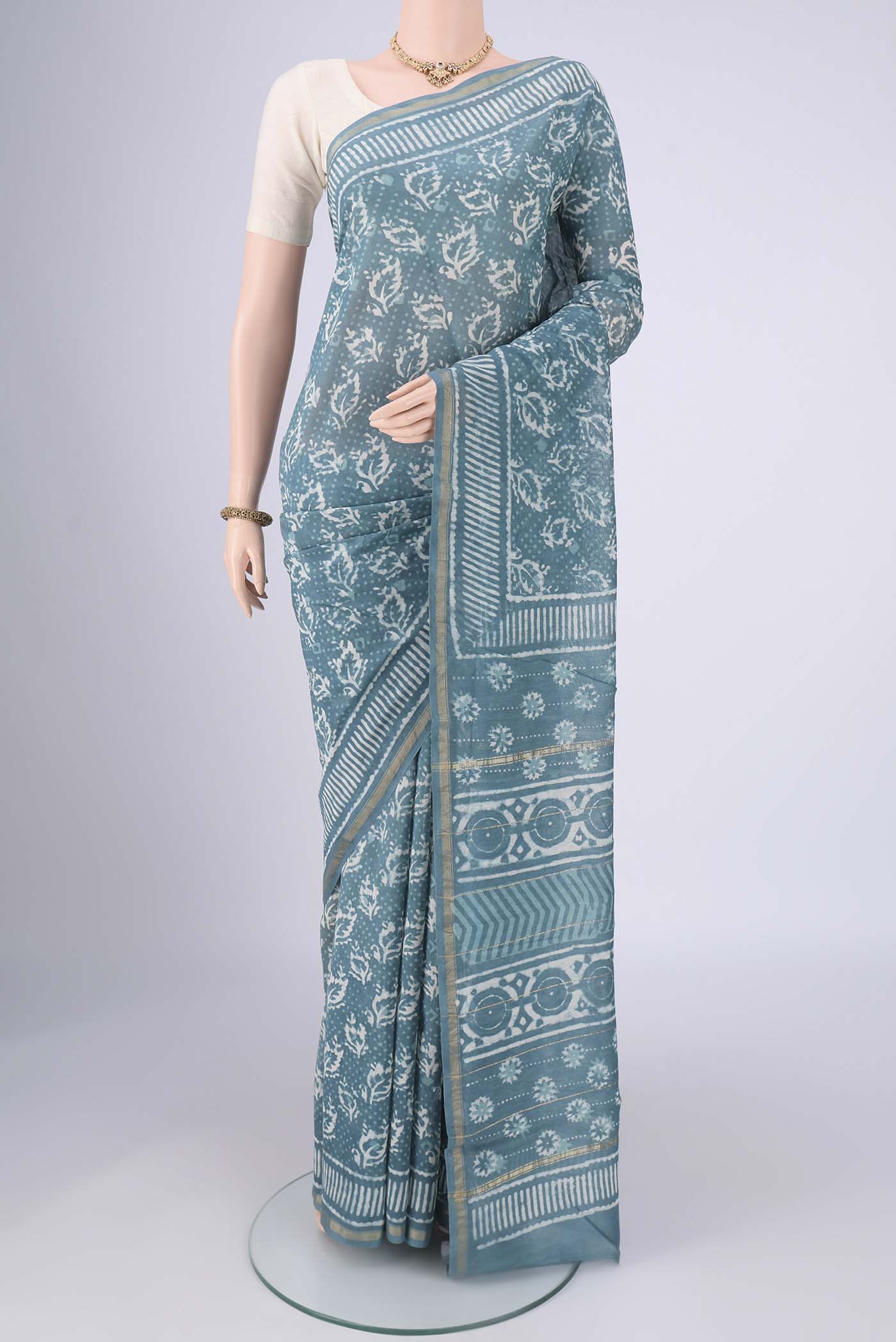 Maya Blue Maheshwari Silk Cotton Saree with Batik Print on the body and Zari Border.  displayed on a mannequin