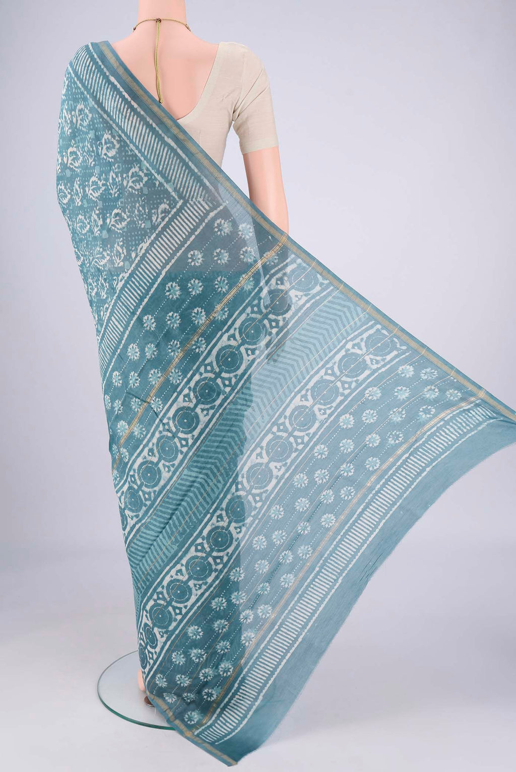 Flat view of Maya Blue Maheshwari Silk Cotton Saree with Batik Print on the body and Zari Border. 