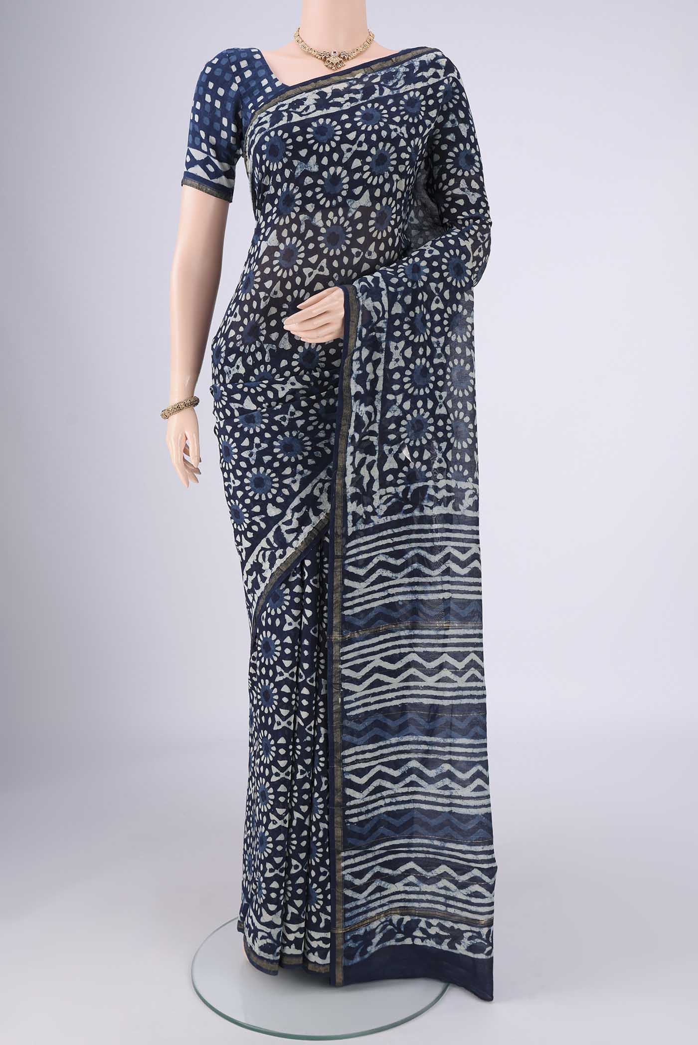 Indigo Maheshwari Silk Cotton Saree with Batik Print on the body and Zari Border.  displayed on a mannequin