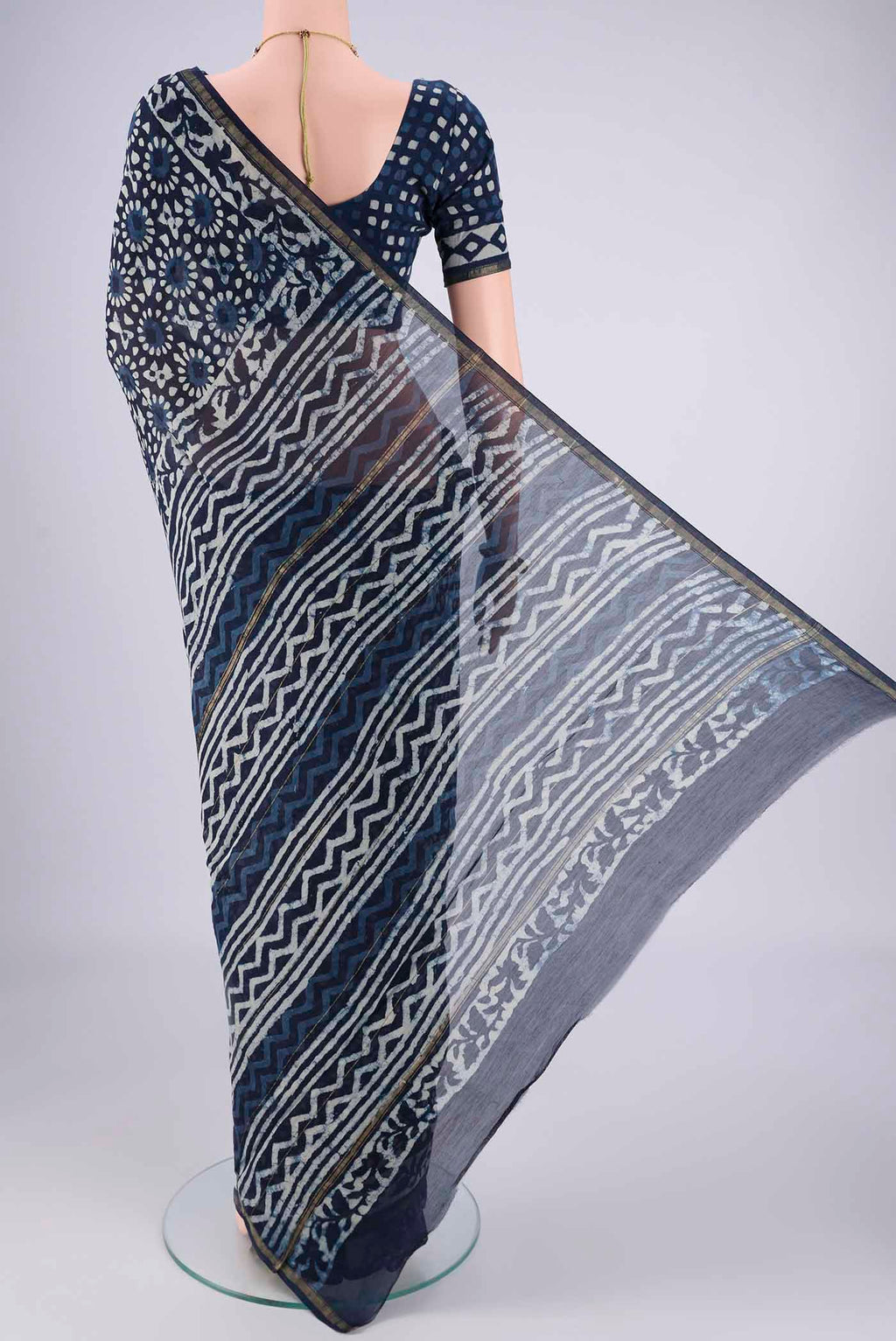 Flat view of Indigo Maheshwari Silk Cotton Saree with Batik Print on the body and Zari Border. 