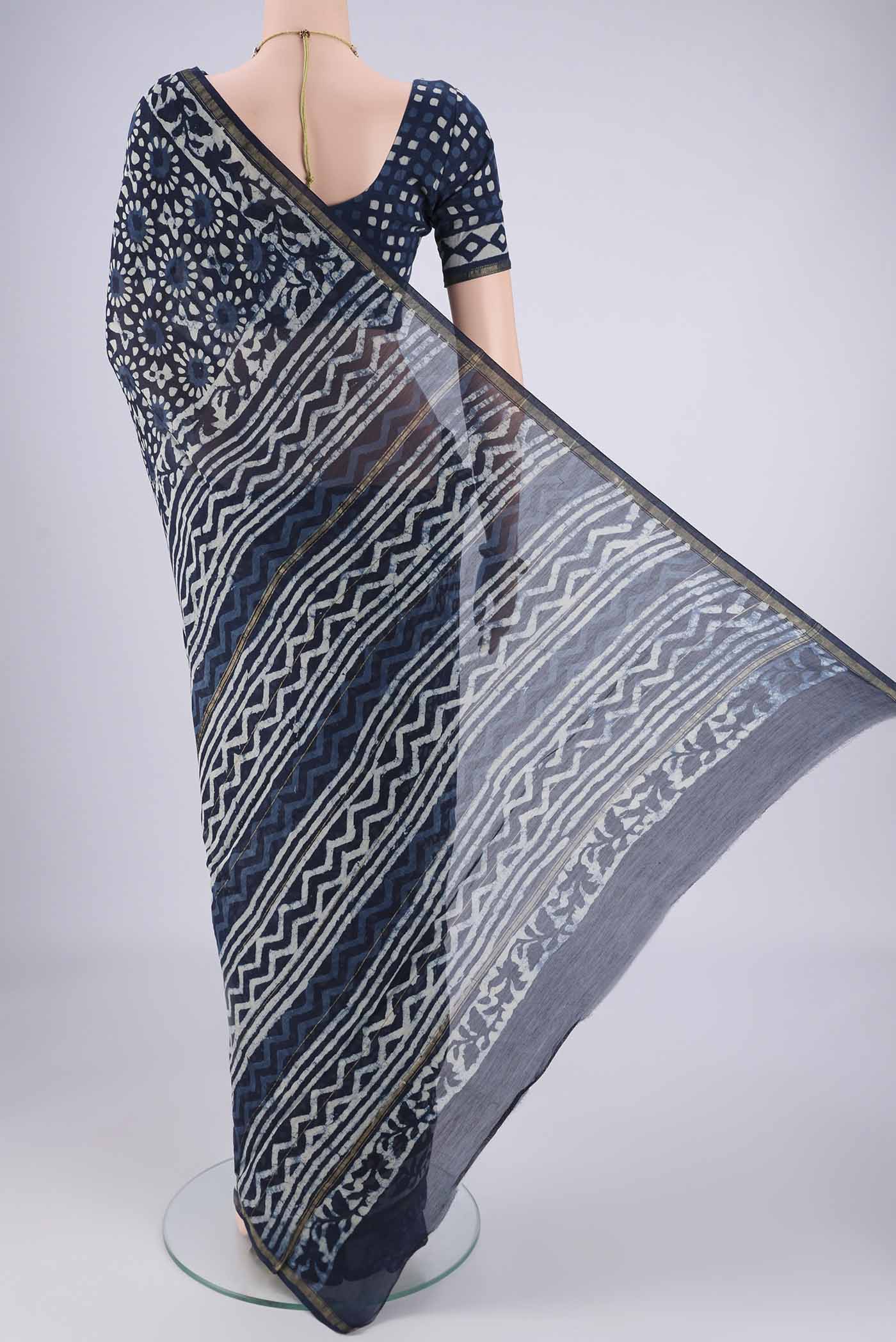 Flat view of Indigo Maheshwari Silk Cotton Saree with Batik Print on the body and Zari Border. 