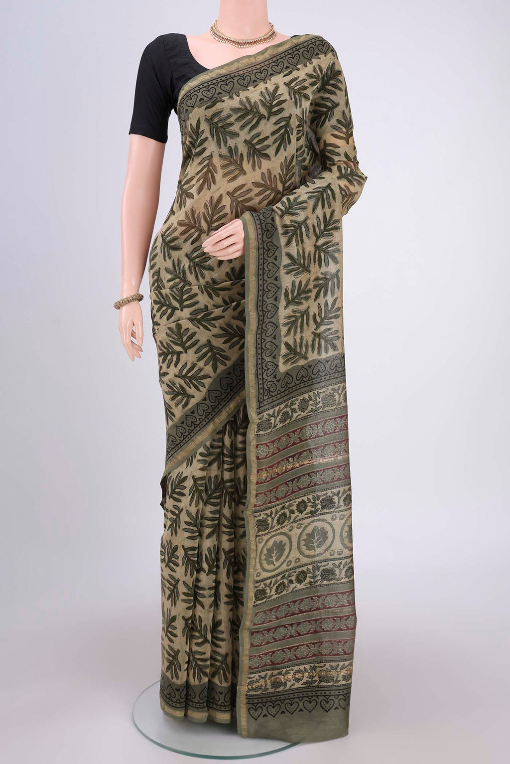 Beige Chanderi Silk Saree with Batik Print on the body and Zari Border.  displayed on a mannequin