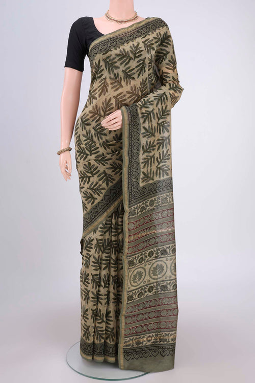 Beige Chanderi Silk Saree with Batik Print on the body and Zari Border.  displayed on a mannequin