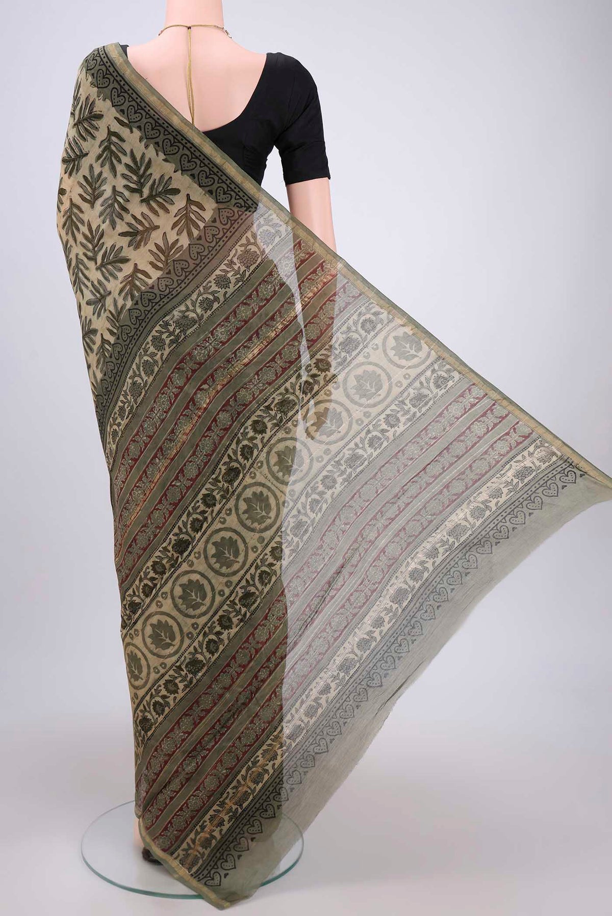 Flat view of Beige Chanderi Silk Saree with Batik Print on the body and Zari Border. 