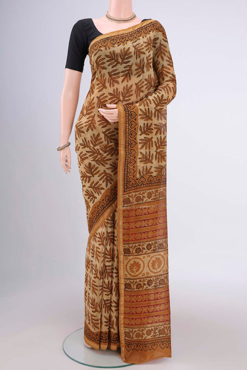 Beige Maheshwari Silk Cotton Saree with Batik Print on the body and Zari Border.  displayed on a mannequin