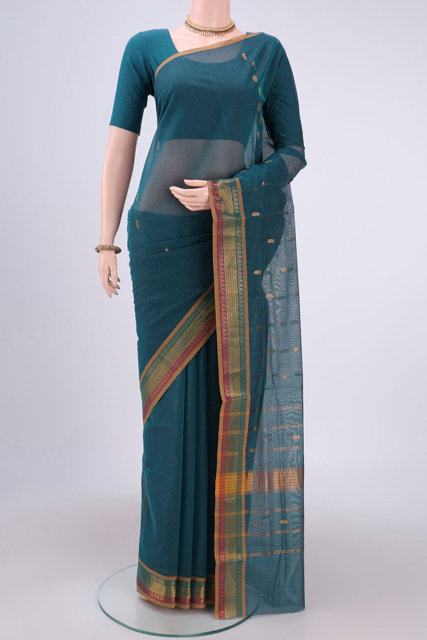 Peacock Blue Cotton Saree with Zari Butta on the body and Zari Border.  displayed on a mannequin