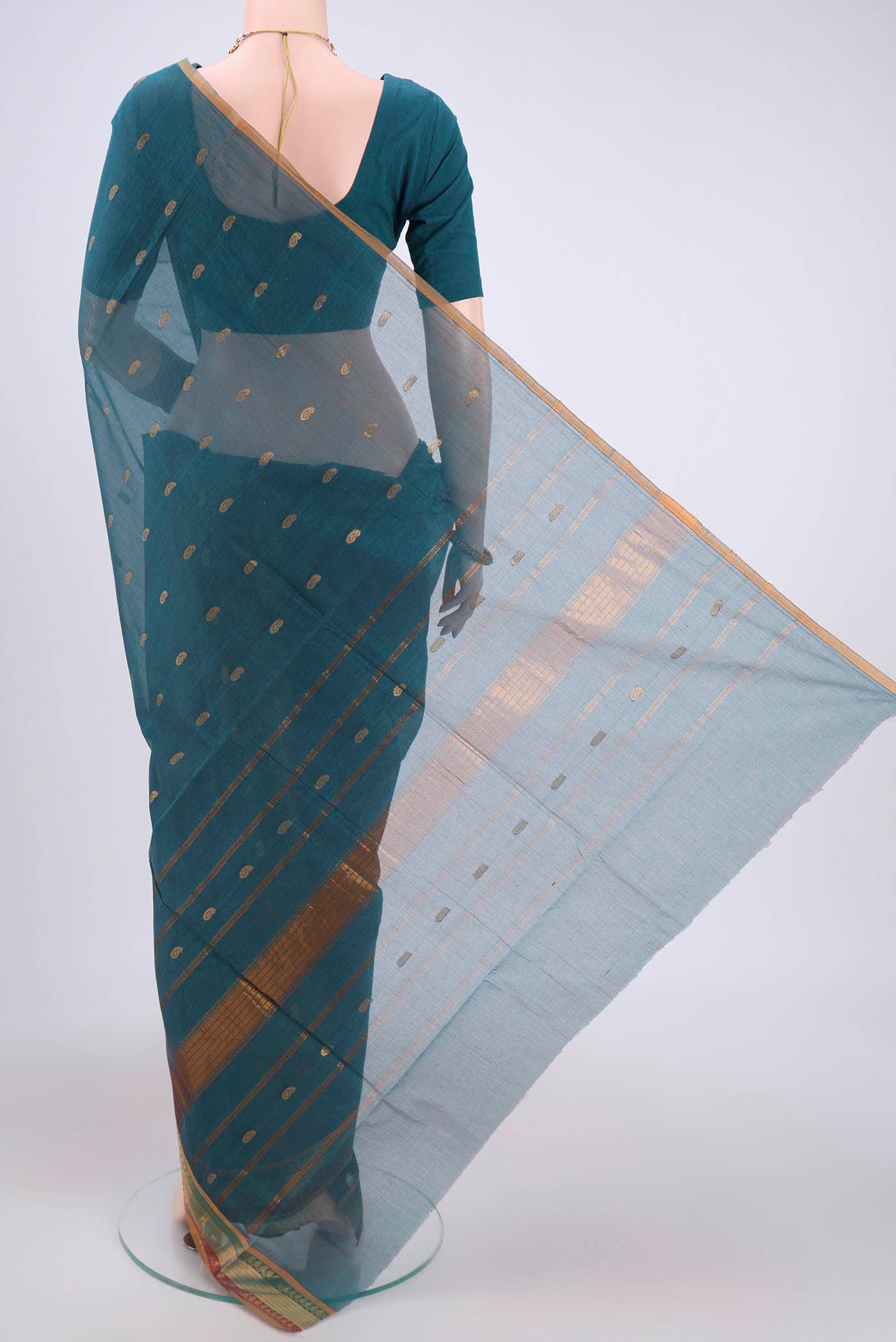 Flat view of Peacock Blue Cotton Saree with Zari Butta on the body and Zari Border. 