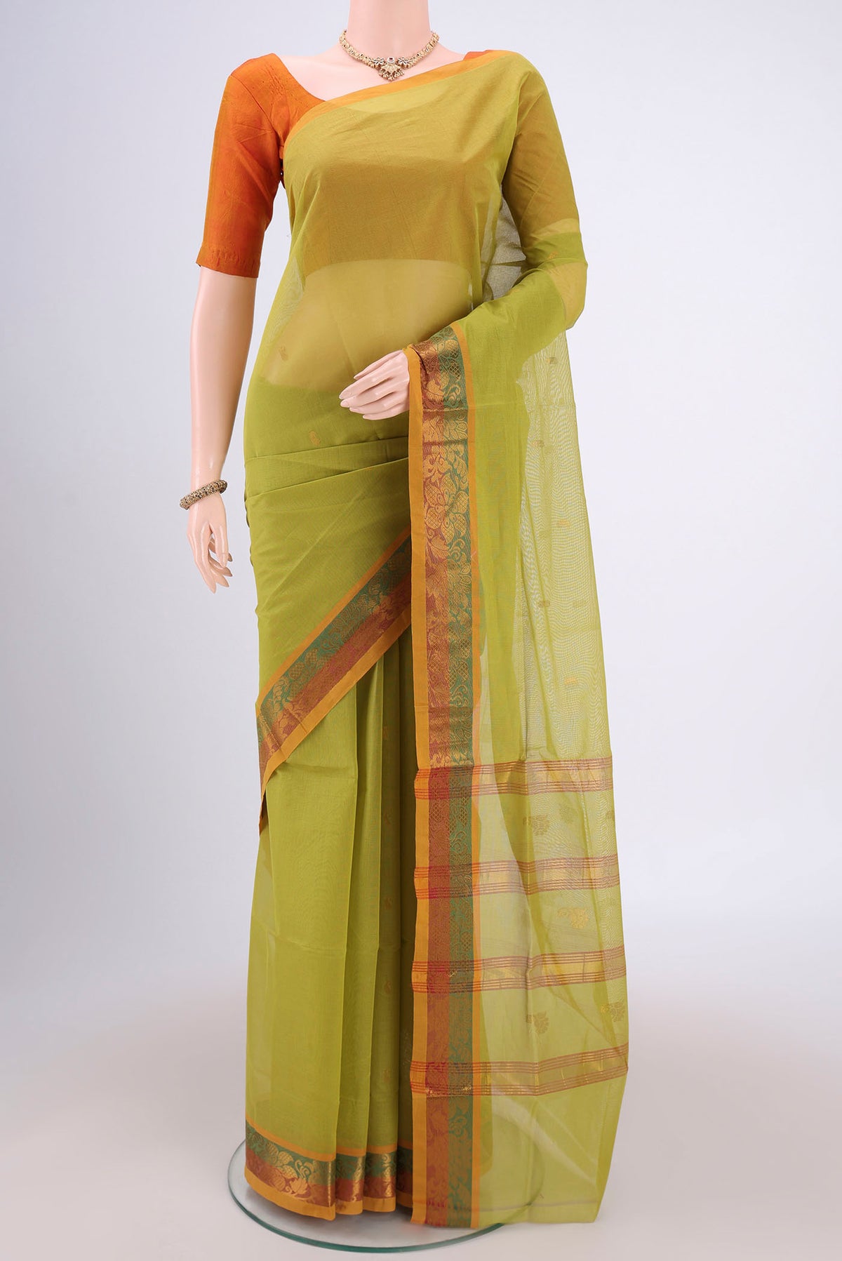 Light Green Venkatagiri Cotton Saree with Zari Butta on the body and Zari Border.  displayed on a mannequin