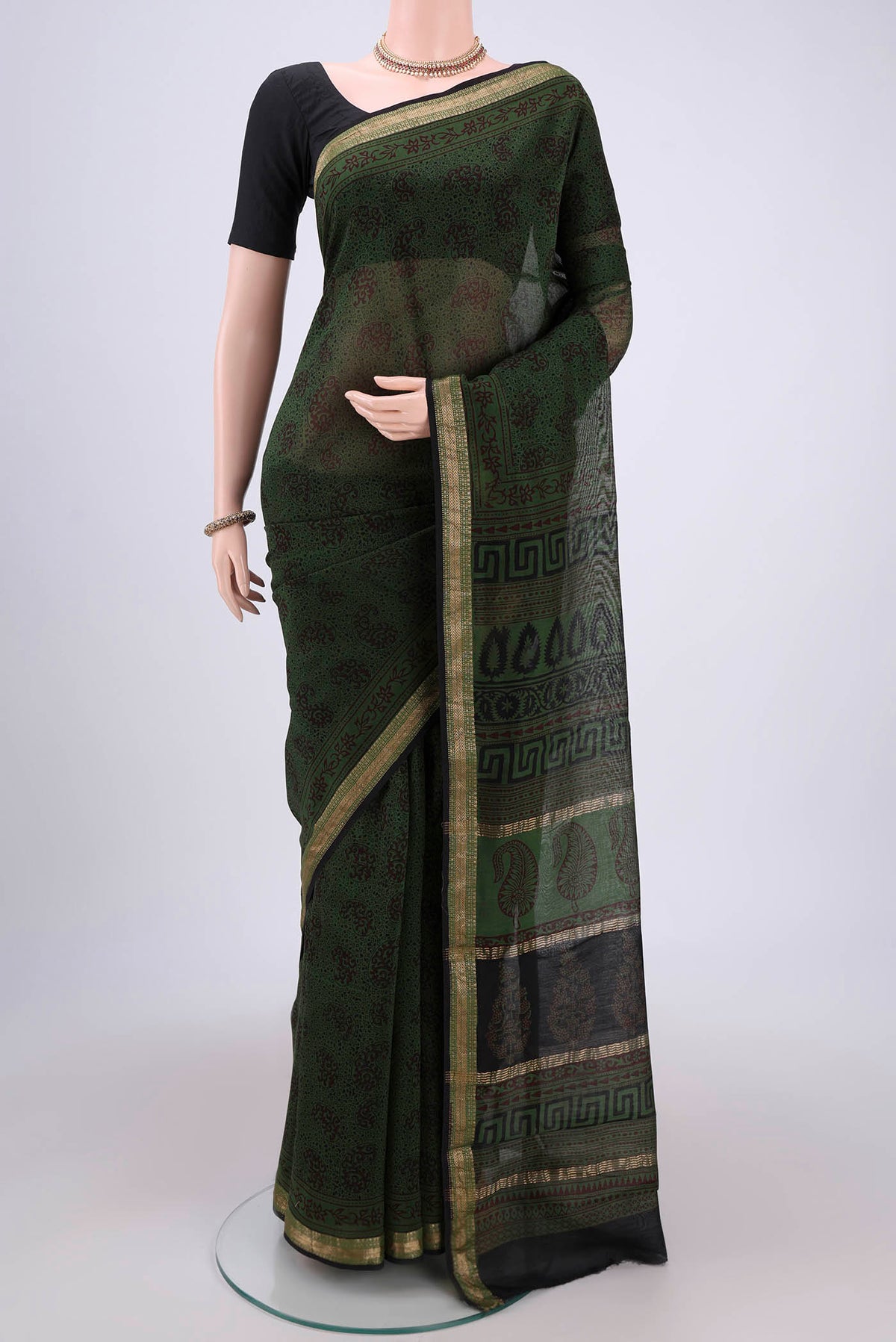 Red Maheshwari Silk Cotton Saree with Printed design on the body and Zari Border.  displayed on a mannequin
