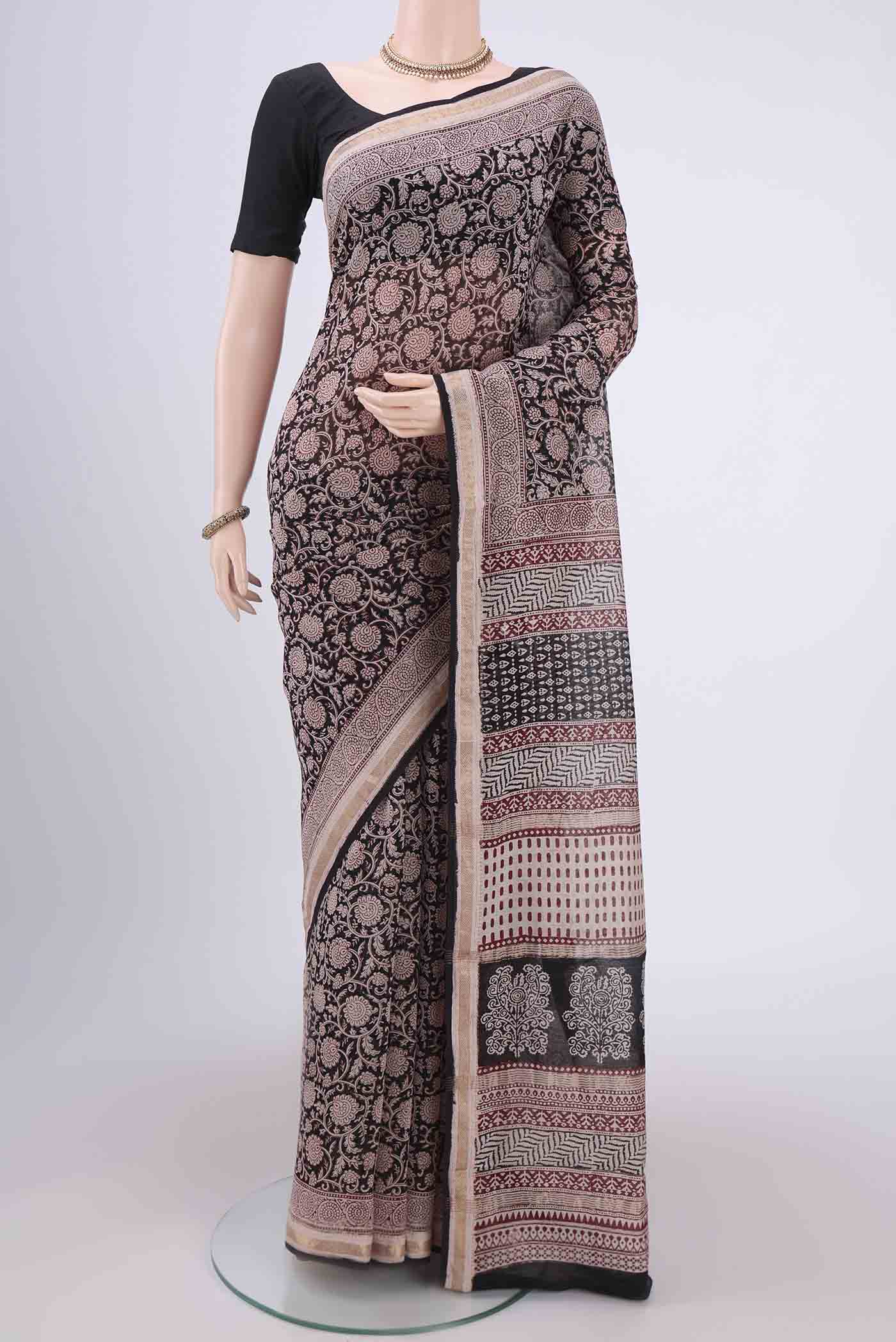 Black Maheshwari Silk Cotton Saree with Printed design on the body and Zari Border.  displayed on a mannequin