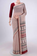 Beige Maheshwari Silk Cotton Saree with Printed design on the body and Zari Border.  displayed on a mannequin