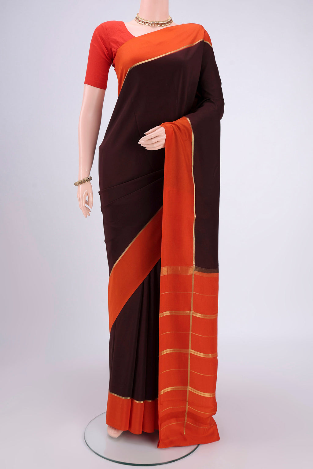 Pure Silk Pure Zari Brown Mysore Crepe Saree with Plain Body and Zari Border.  displayed on a mannequin