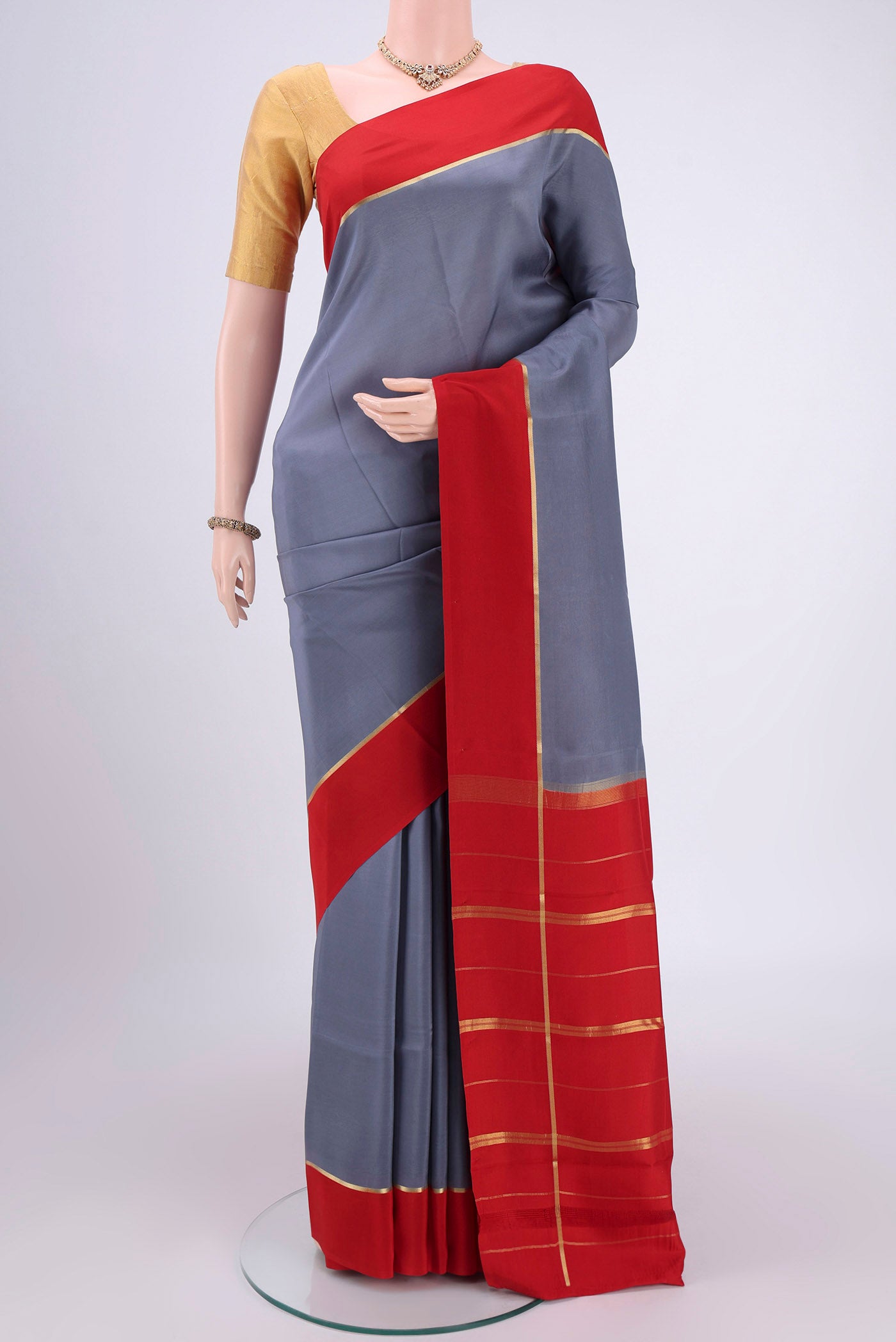 Pure Silk Pure Zari Grey Mysore Crepe Saree with Plain Body and Zari Border.  displayed on a mannequin