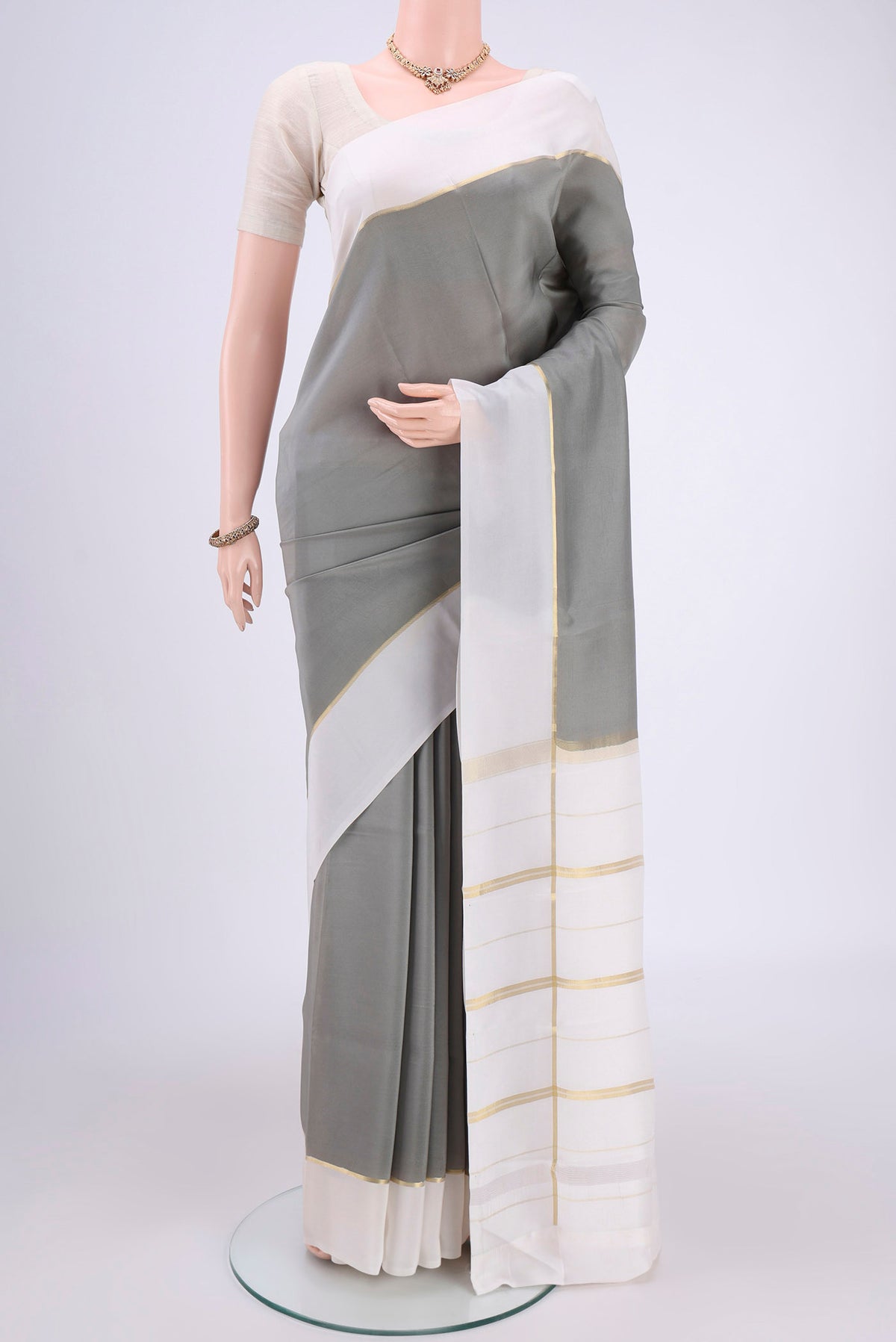Pure Silk Pure Zari Grey Mysore Crepe Saree with Plain Body and Zari Border.  displayed on a mannequin