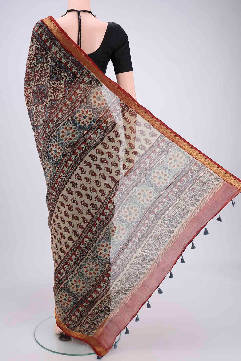 Flat view of Beige Chanderi Silk Cotton Saree with Ajrakh Print on the body and Zari Border. 