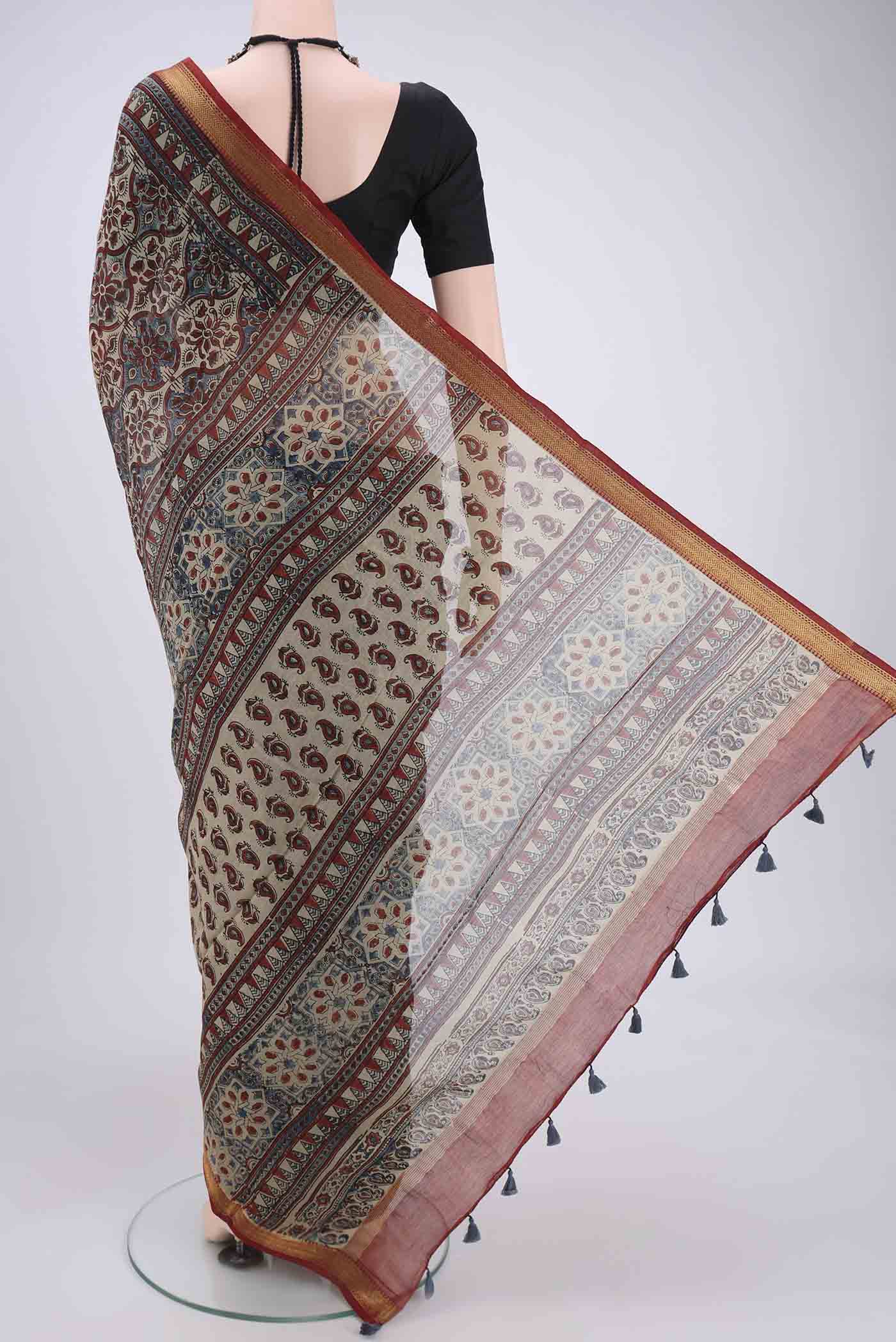 Flat view of Beige Chanderi Silk Cotton Saree with Ajrakh Print on the body and Zari Border. 