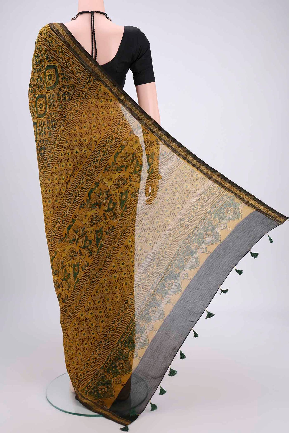 Flat view of Yellow Chanderi Silk Cotton Saree with Ajrakh Print on the body and Zari Border. 