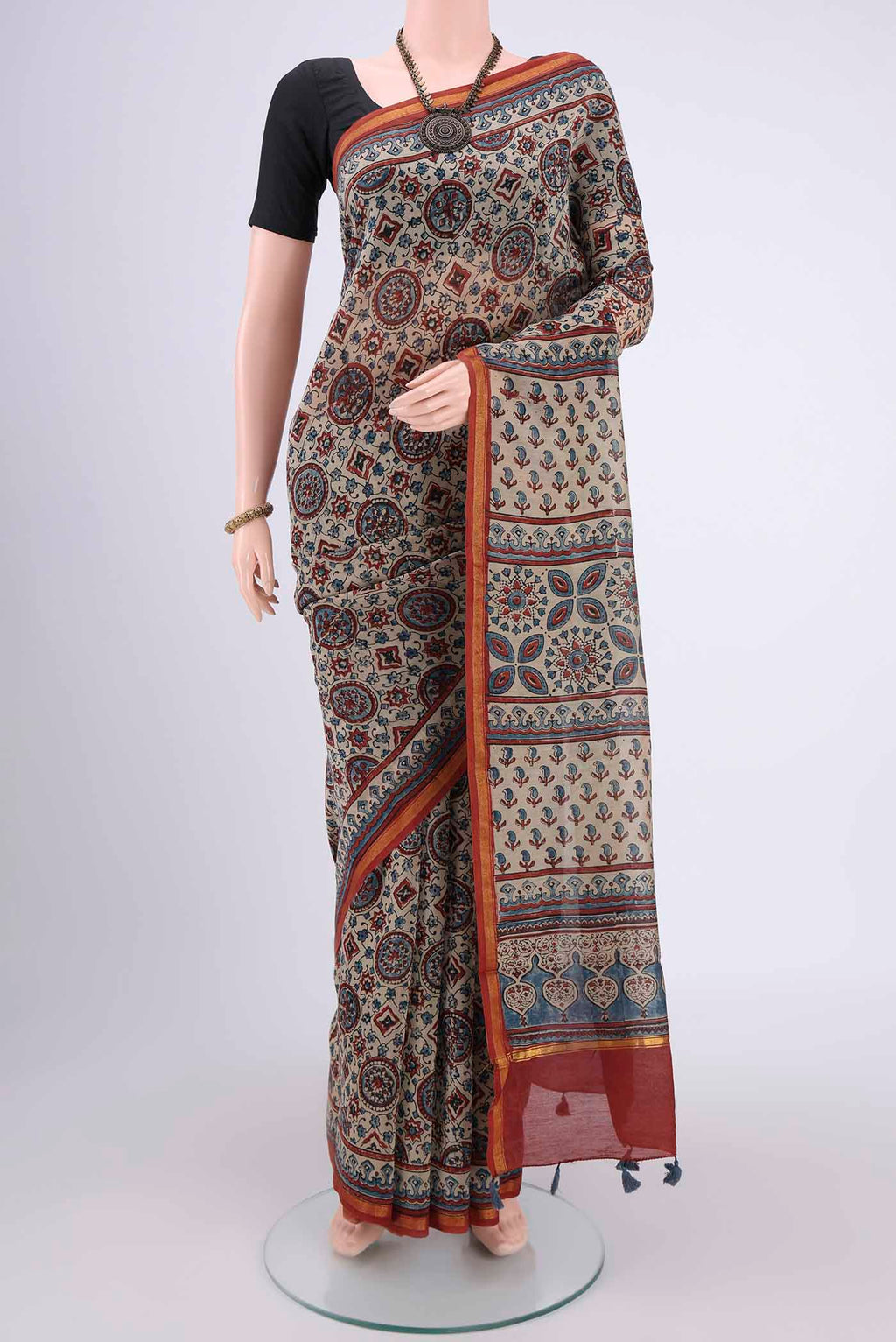 Beige Chanderi Silk Cotton Saree with Ajrakh Print on the body and Zari Border.  displayed on a mannequin