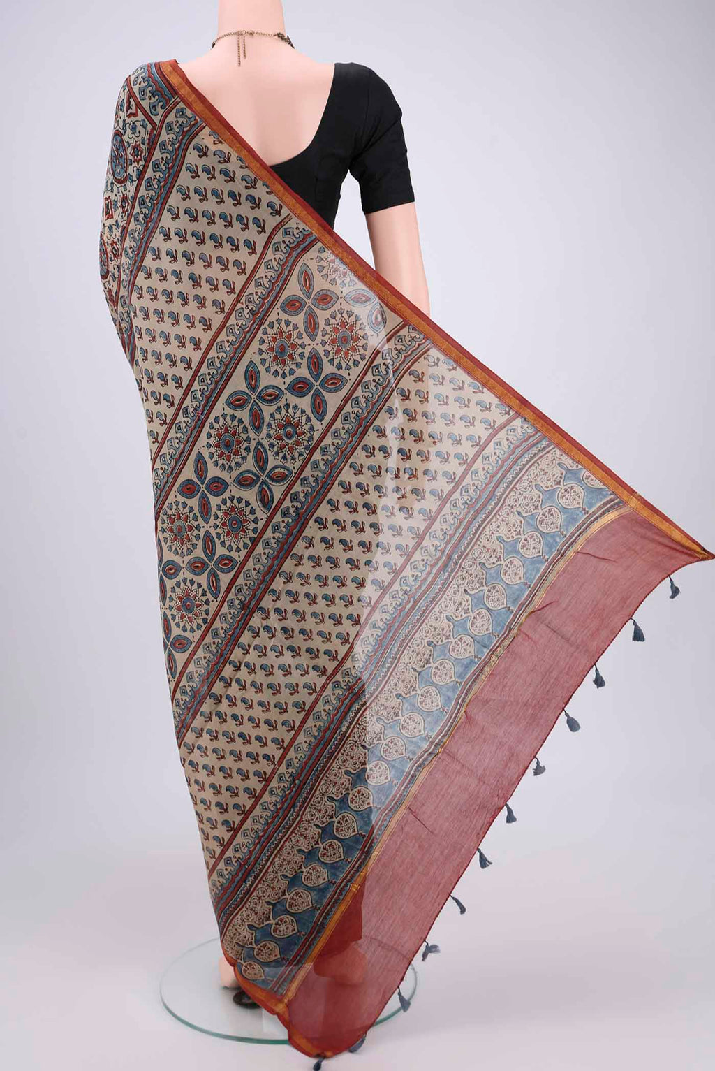 Flat view of Beige Chanderi Silk Cotton Saree with Ajrakh Print on the body and Zari Border. 