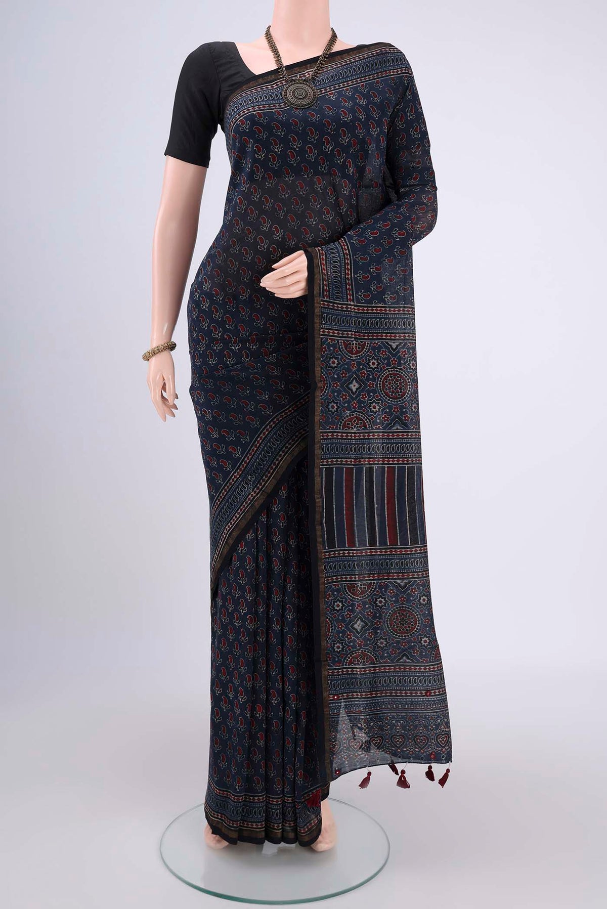 Navy Blue Chanderi Silk Cotton Saree with Ajrakh Print on the body and Zari Border.  displayed on a mannequin