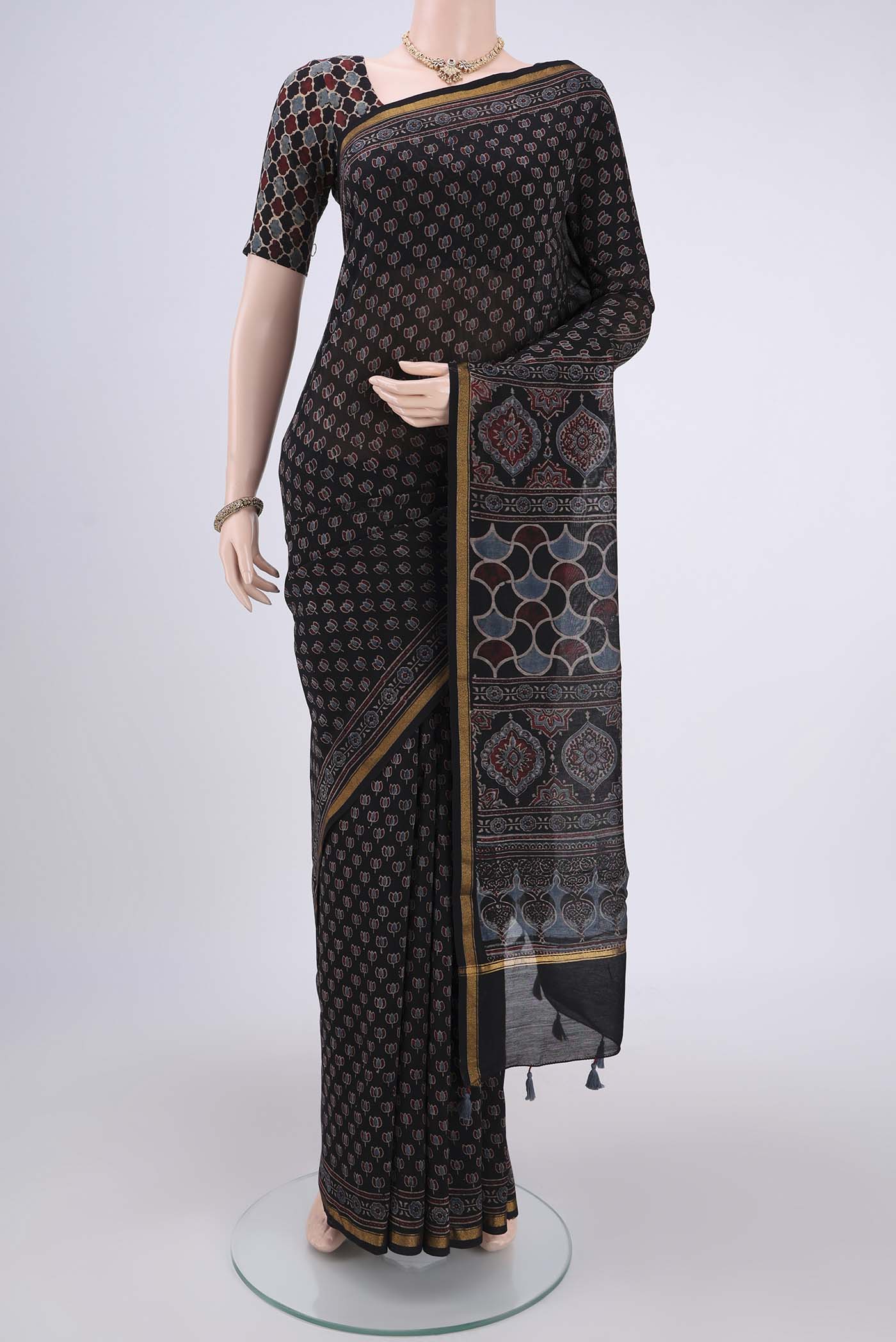 Black Chanderi Silk Cotton Saree with Ajrakh Print on the body and Zari Border.  displayed on a mannequin