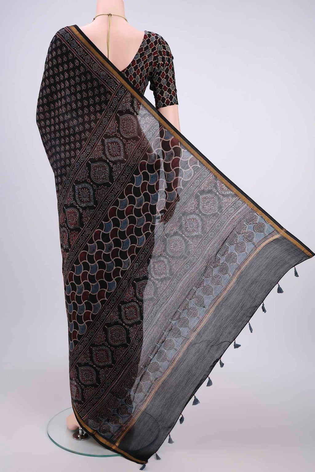 Flat view of Black Chanderi Silk Cotton Saree with Ajrakh Print on the body and Zari Border. 
