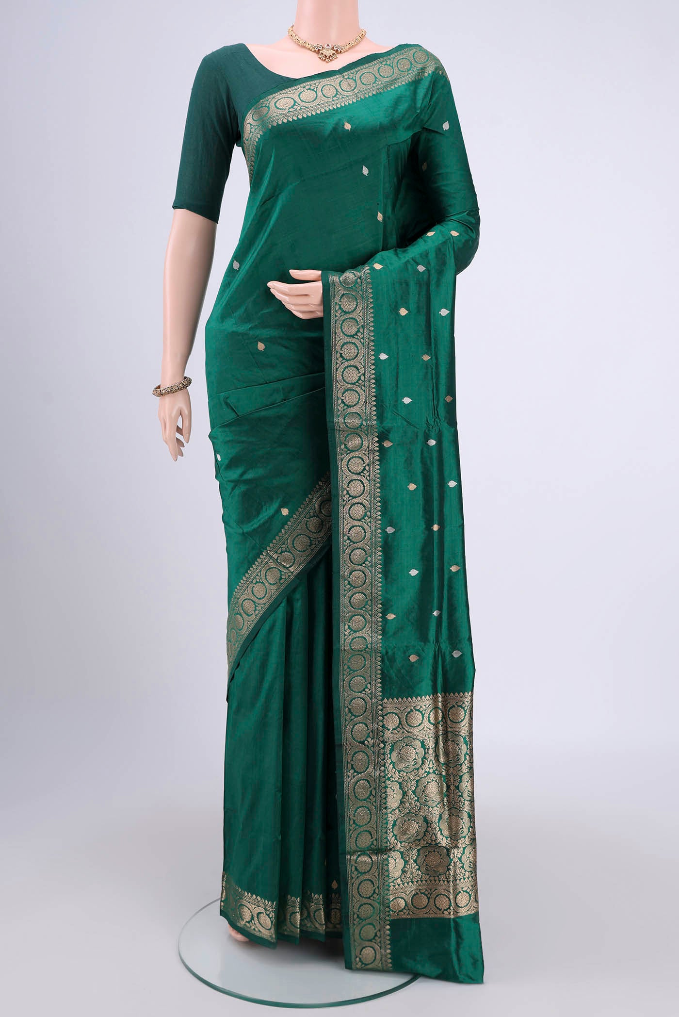 Green Banarasi Katan Silk Saree with Zari Butta on the body and Zari Border.  displayed on a mannequin