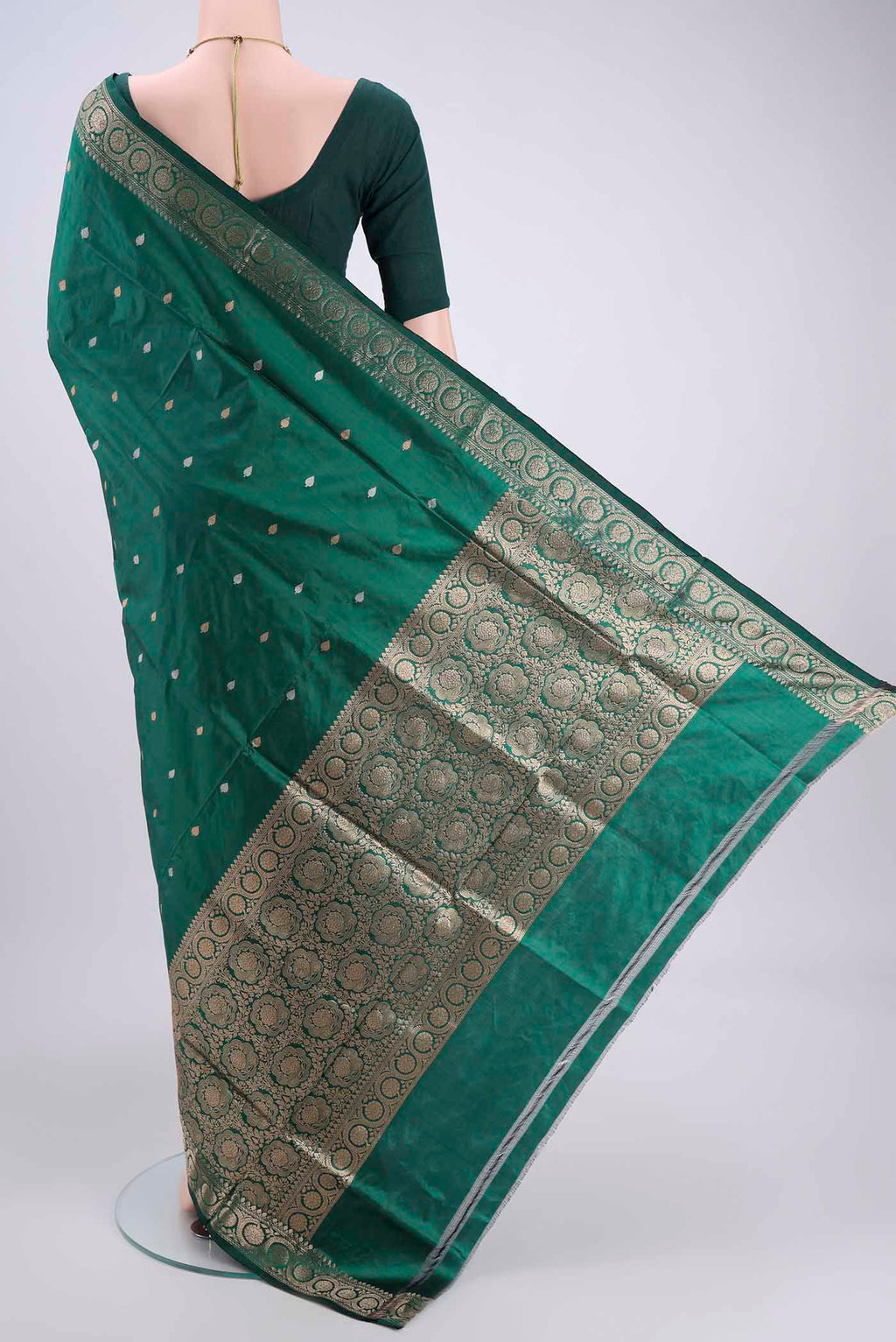 Flat view of Green Banarasi Katan Silk Saree with Zari Butta on the body and Zari Border. 