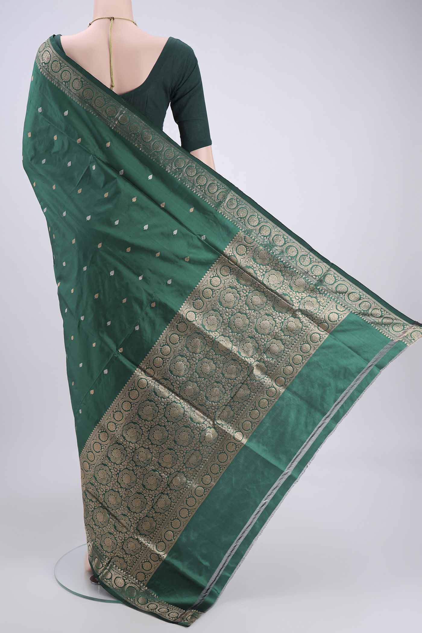 Flat view of Green Banarasi Katan Silk Saree with Zari Butta on the body and Zari Border. 
