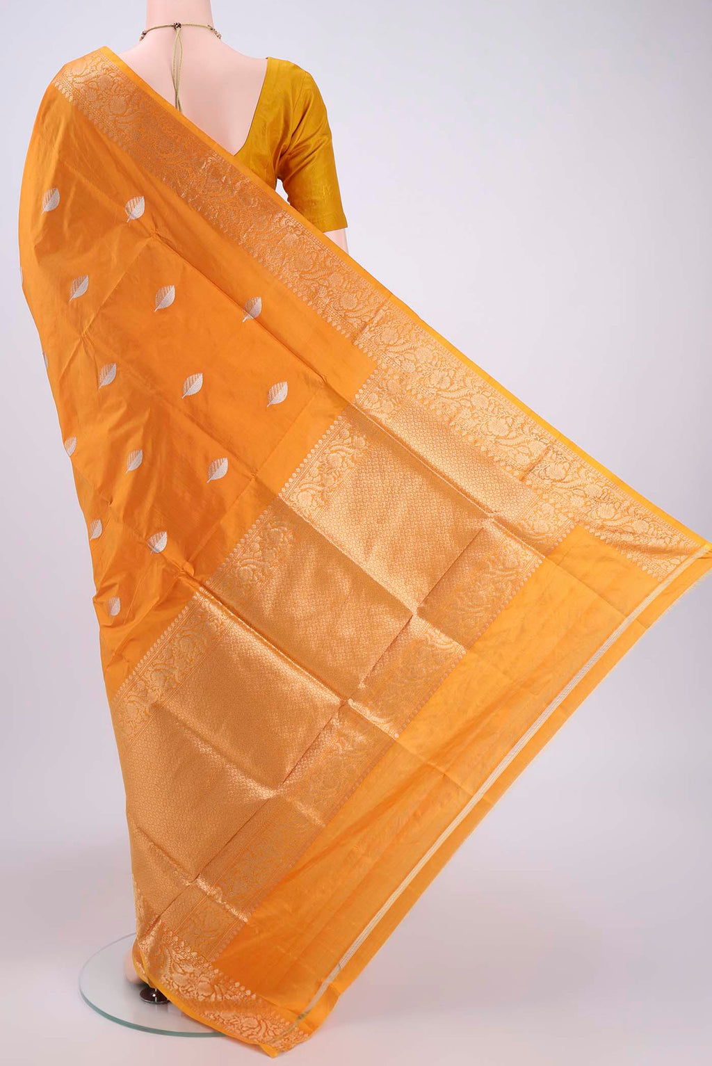 Flat view of Orange Banarasi Katan Silk Saree with Zari Butta on the body and Zari Border. 