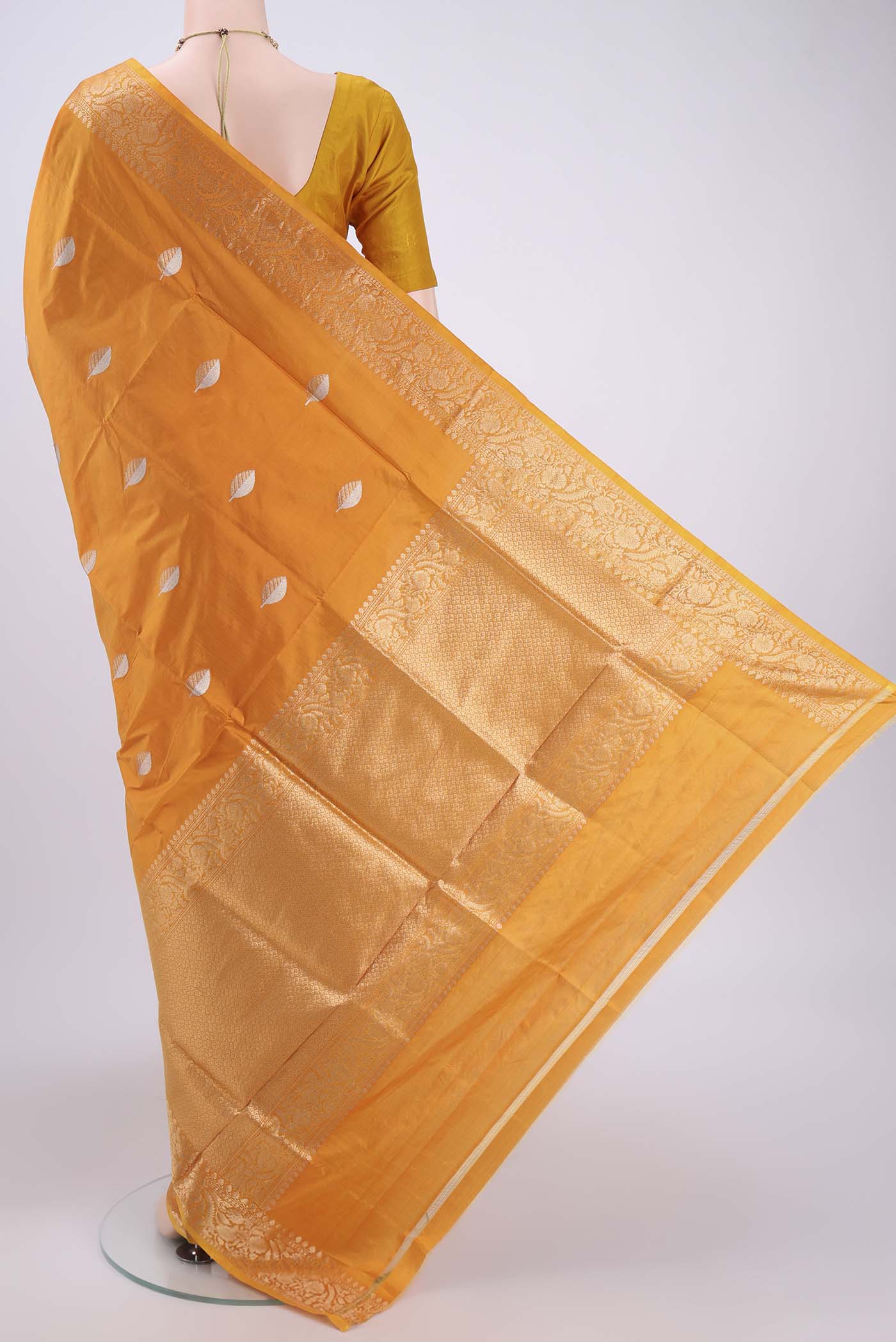 Flat view of Orange Banarasi Katan Silk Saree with Zari Butta on the body and Zari Border. 