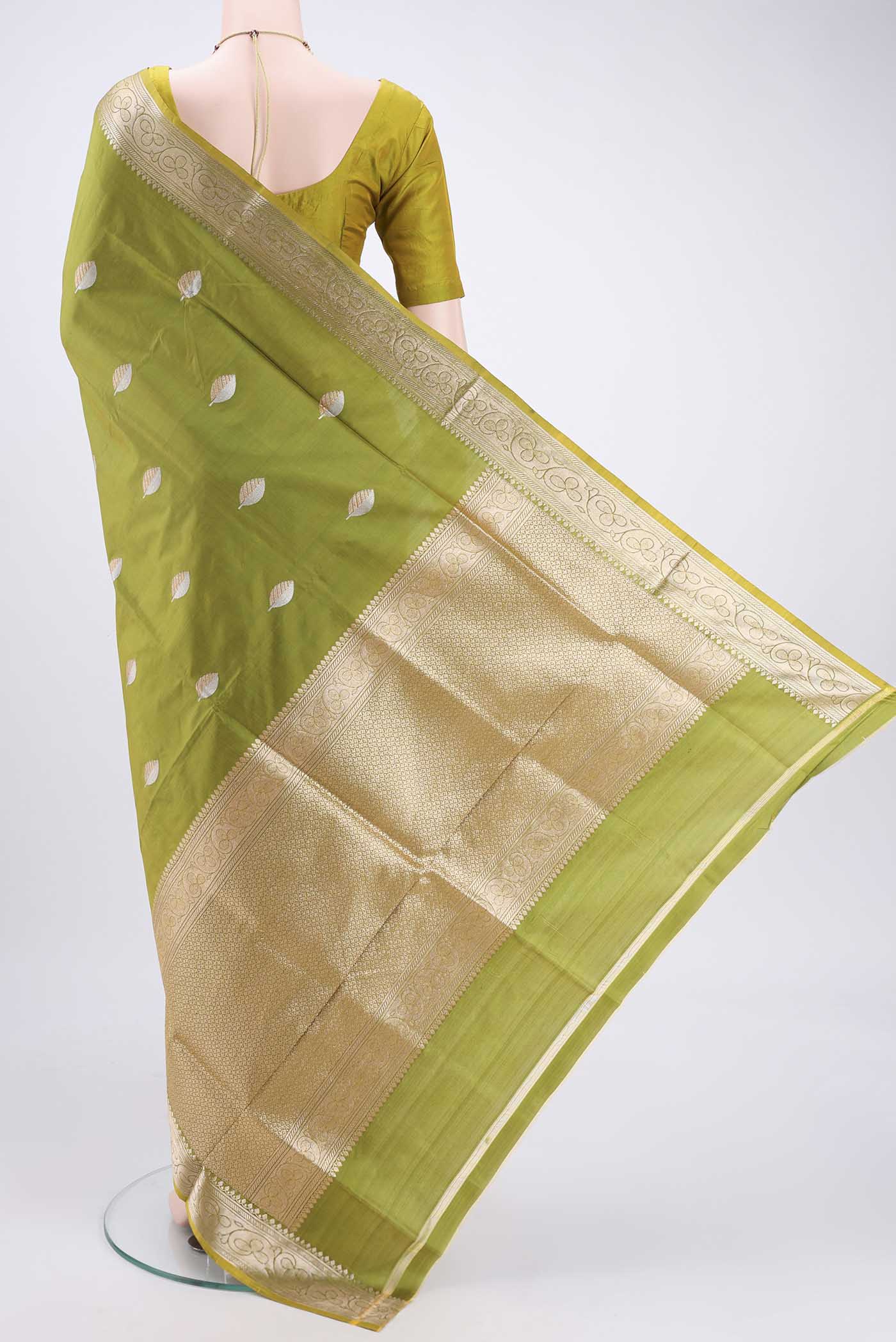Flat view of Light Green Banarasi Katan Silk Saree with Zari Butta on the body and Zari Border. 