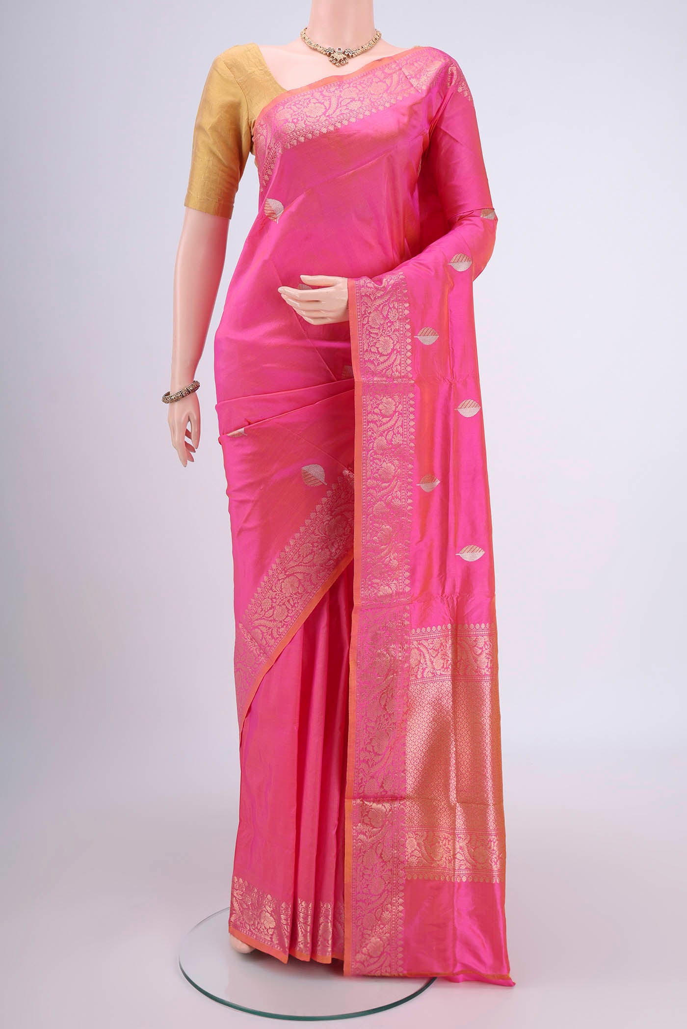 Pinkish Yellow Dual Tone Banarasi Katan Silk Saree with Zari Butta on the body and Zari Border.  displayed on a mannequin