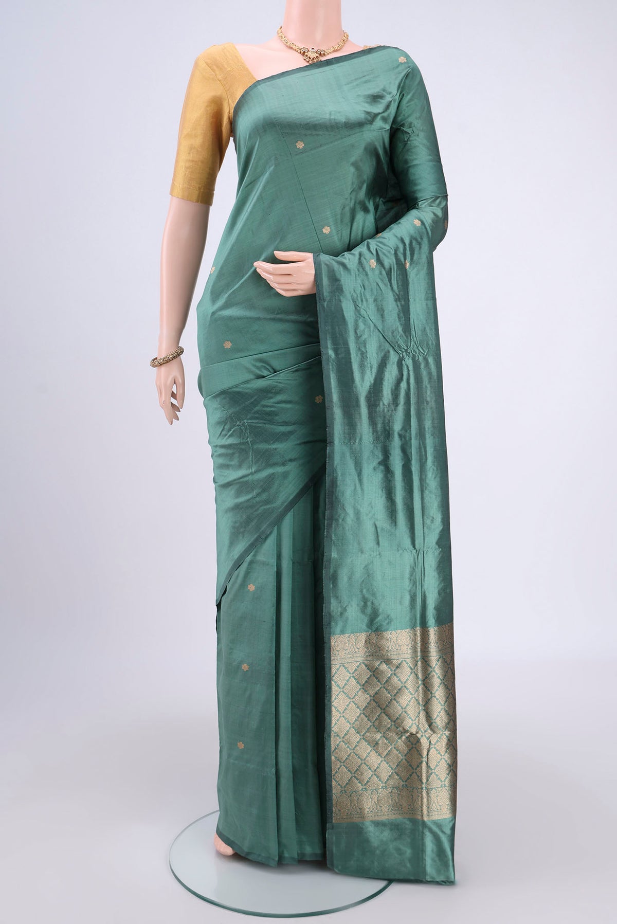 Sage Green Banarasi Katan Silk Saree with Zari Butta on the body and Without Border.  displayed on a mannequin