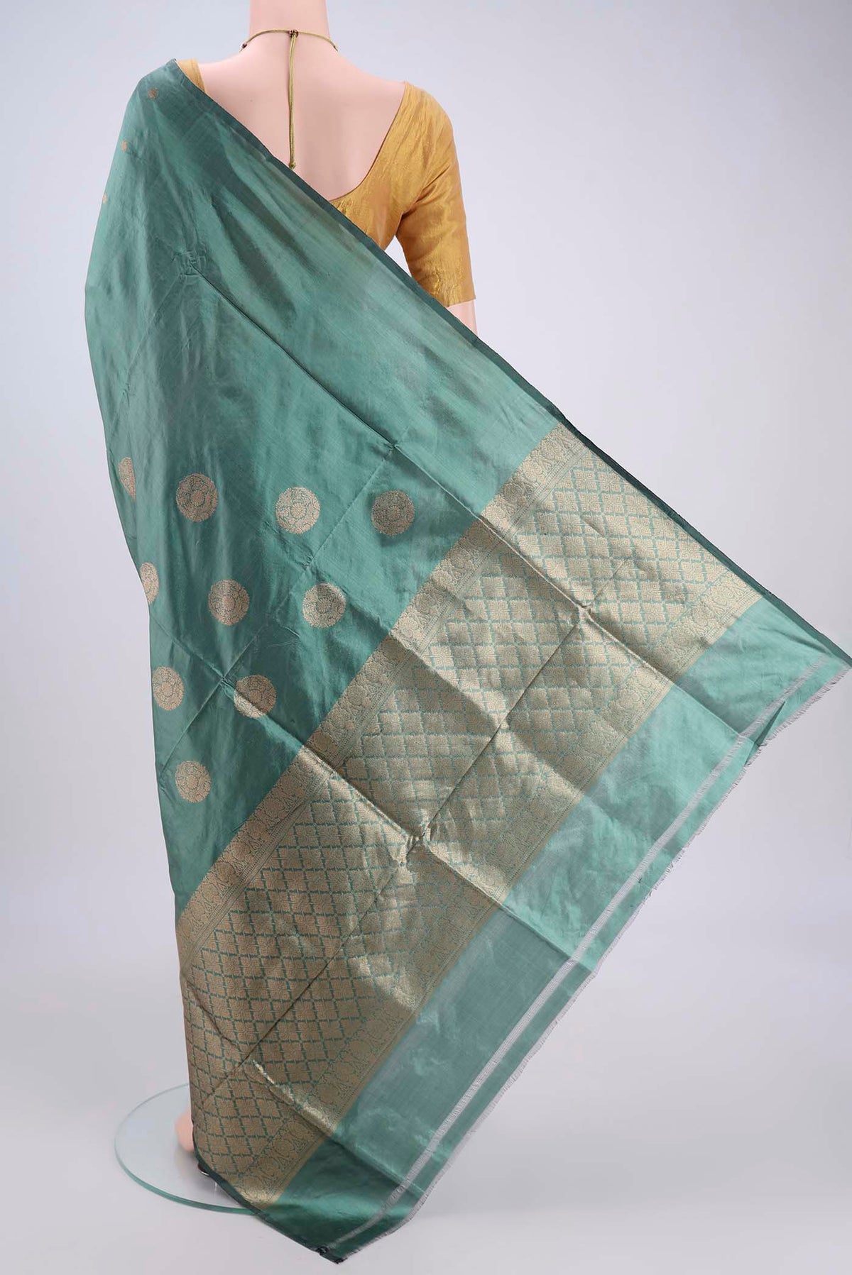Flat view of Sage Green Banarasi Katan Silk Saree with Zari Butta on the body and Without Border. 
