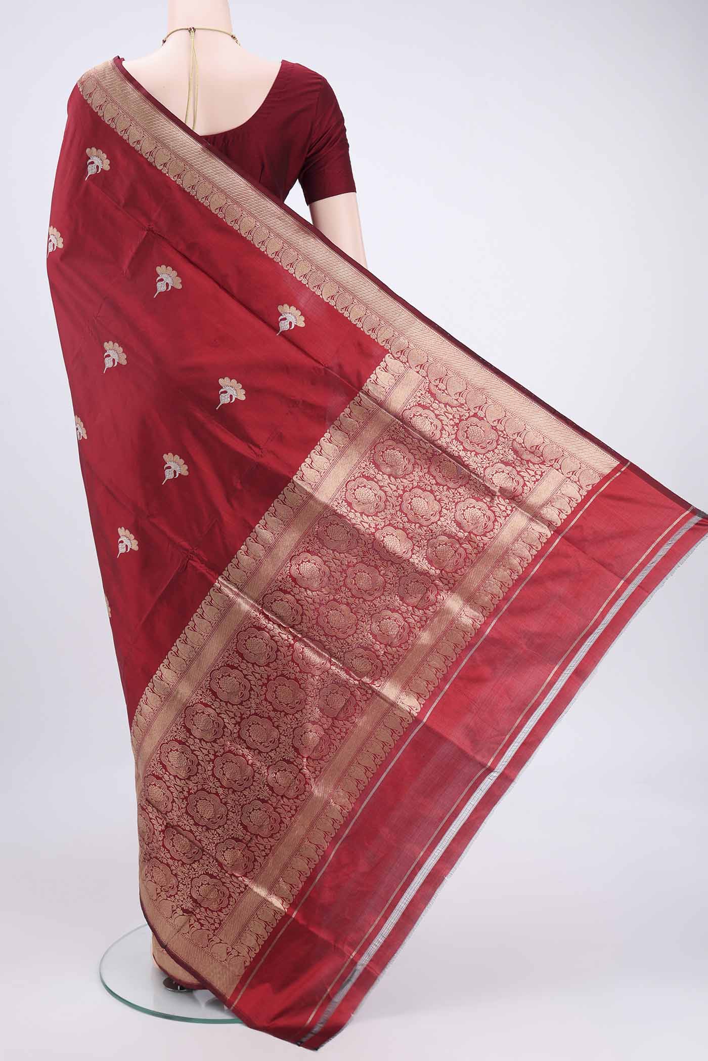 Flat view of Maroon Banarasi Katan Silk Saree with Zari Butta on the body and Zari Border. 