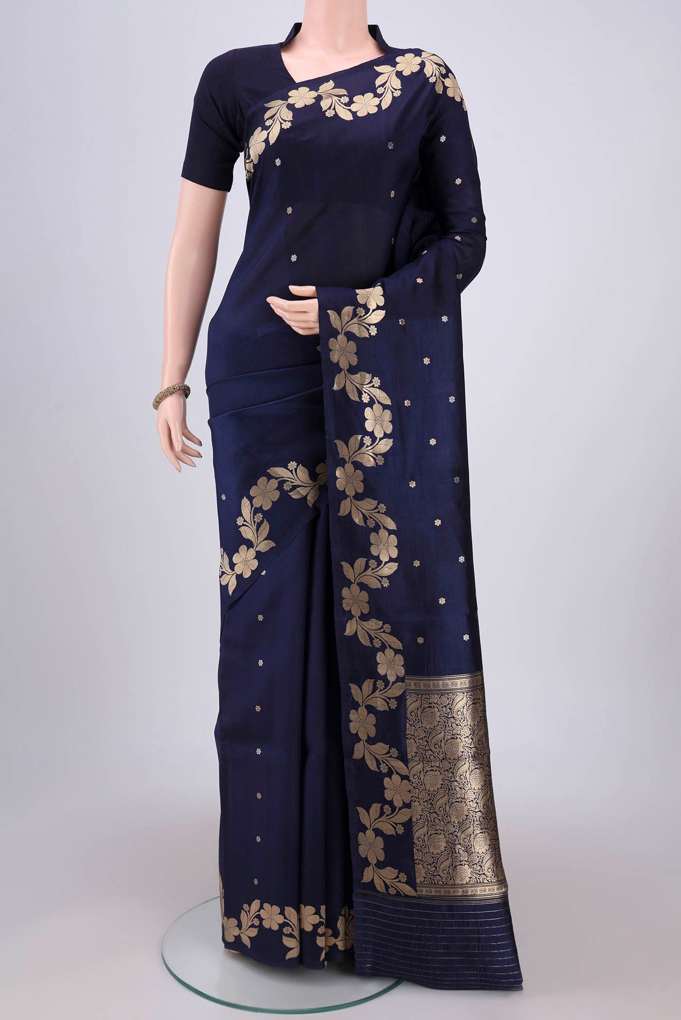 Navy Blue Banarasi Katan Silk Saree with Zari Butta on the body and Zari Border.  displayed on a mannequin