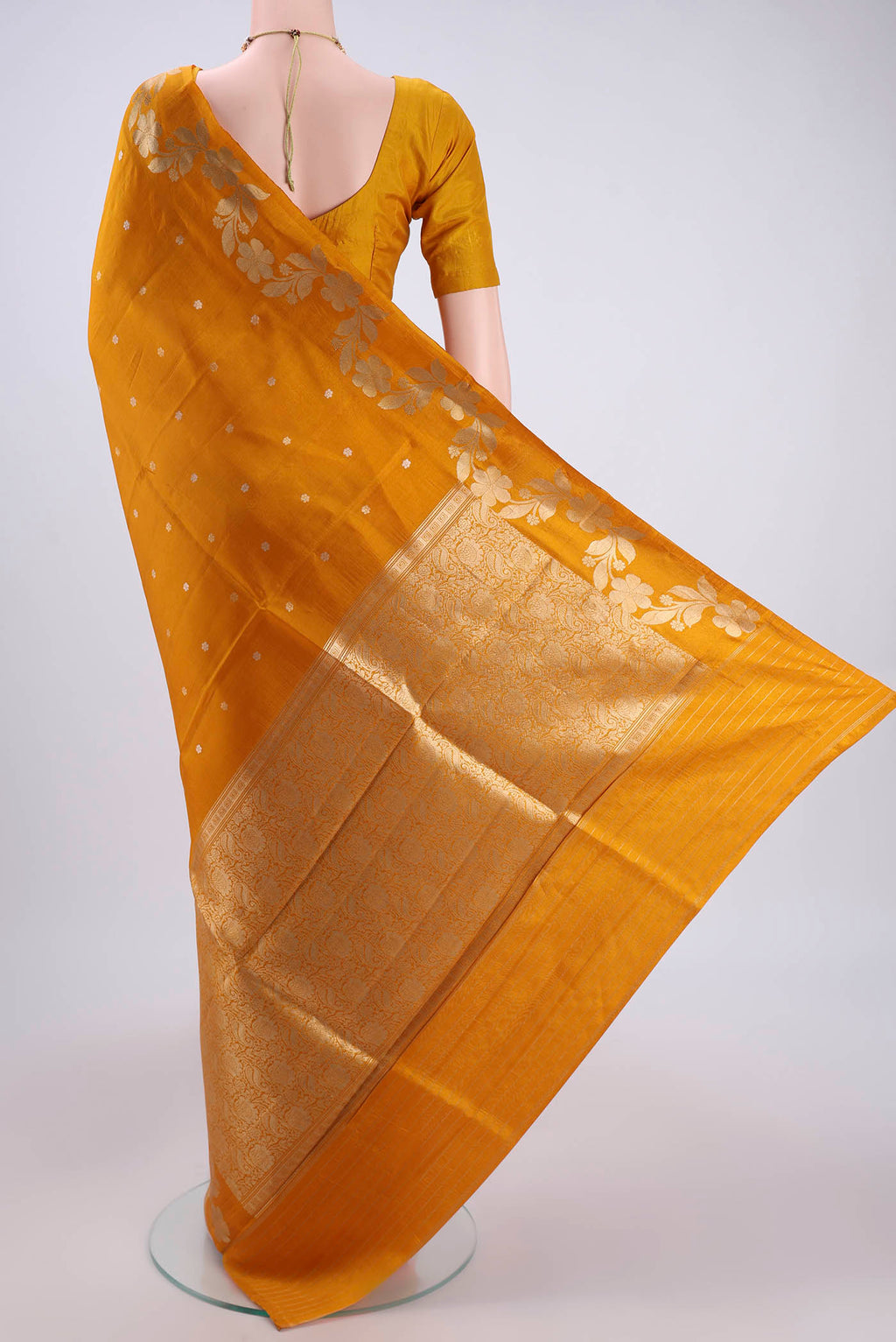 Flat view of Mustard Banarasi Katan Silk Saree with Zari Butta on the body and Zari Border. 
