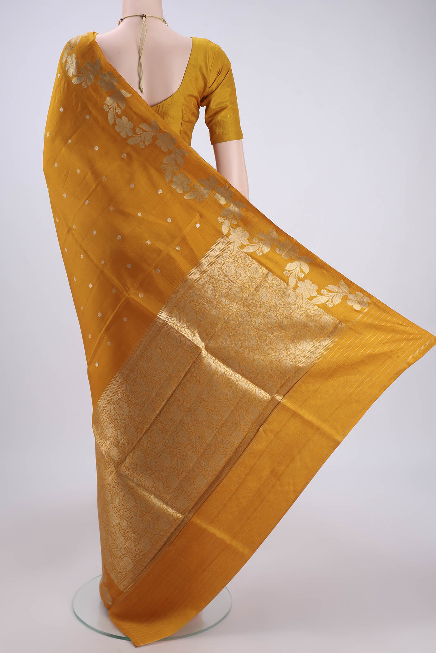 Flat view of Mustard Banarasi Katan Silk Saree with Zari Butta on the body and Zari Border. 