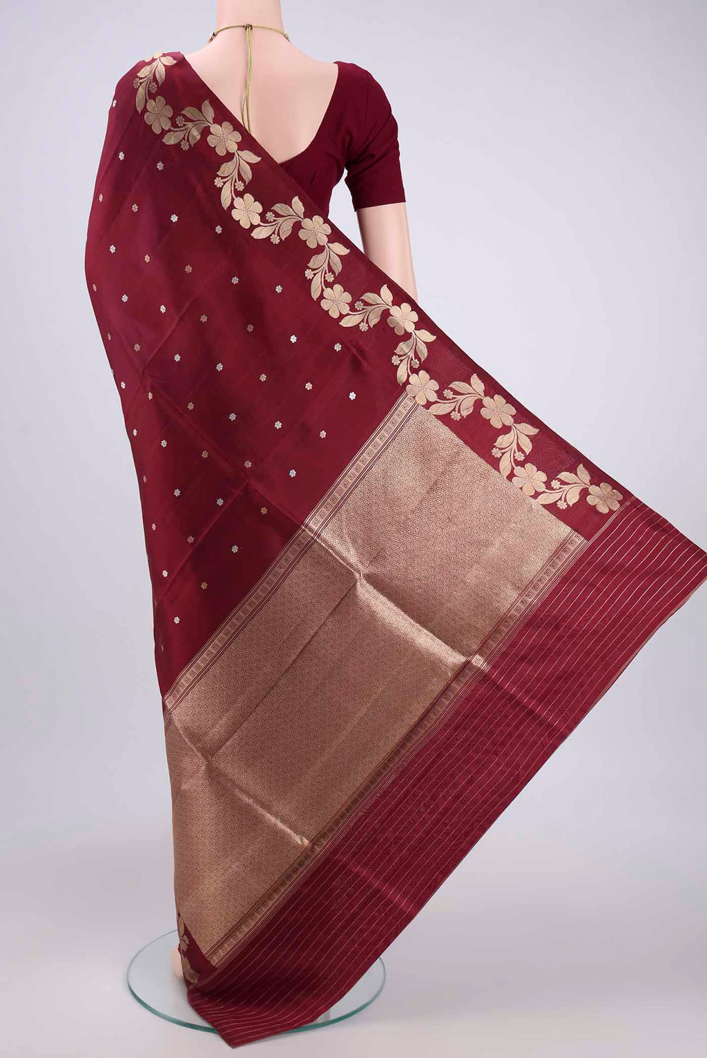 Flat view of Maroon Banarasi Katan Silk Saree with Zari Butta on the body and Zari Border. 
