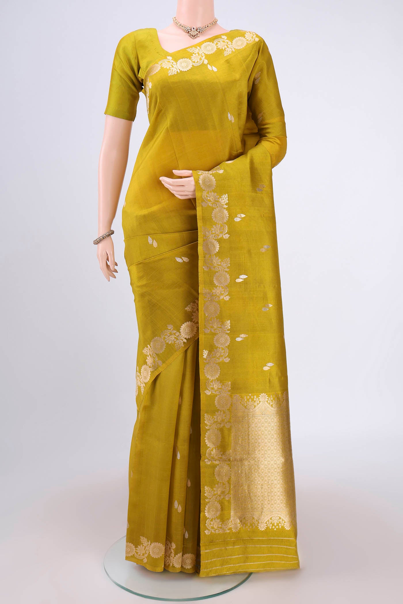 Mehandi Green Banarasi Katan Silk Saree with Zari Butta on the body and Zari Border.  displayed on a mannequin
