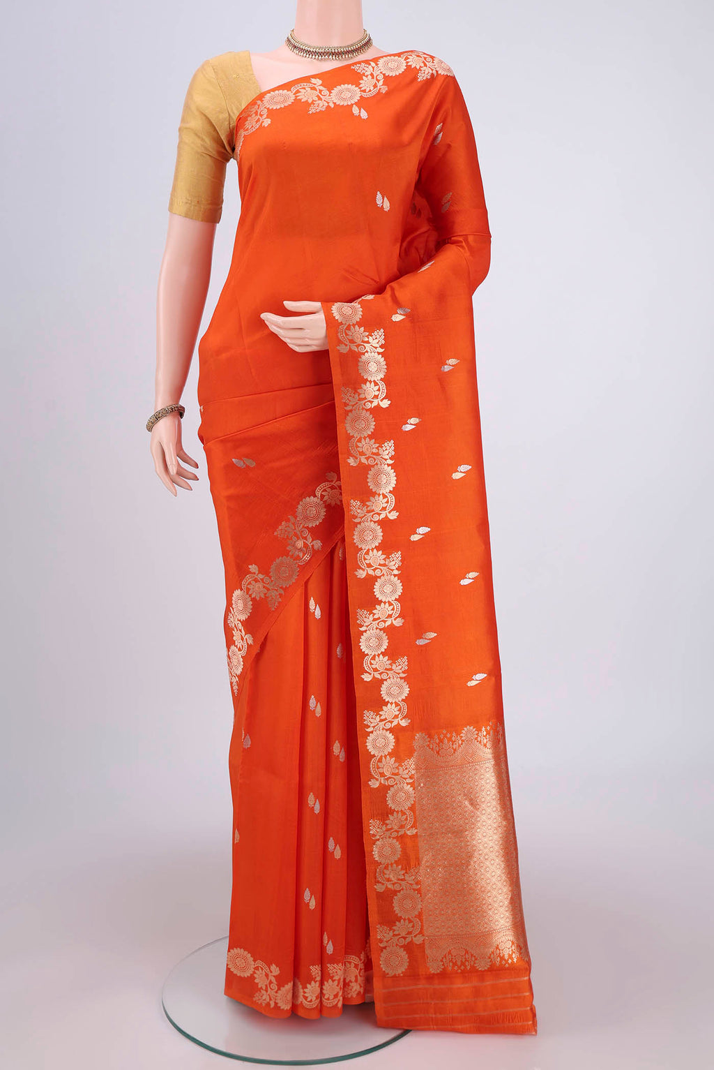 Rust Banarasi Katan Silk Saree with Zari Butta on the body and Zari Border.  displayed on a mannequin