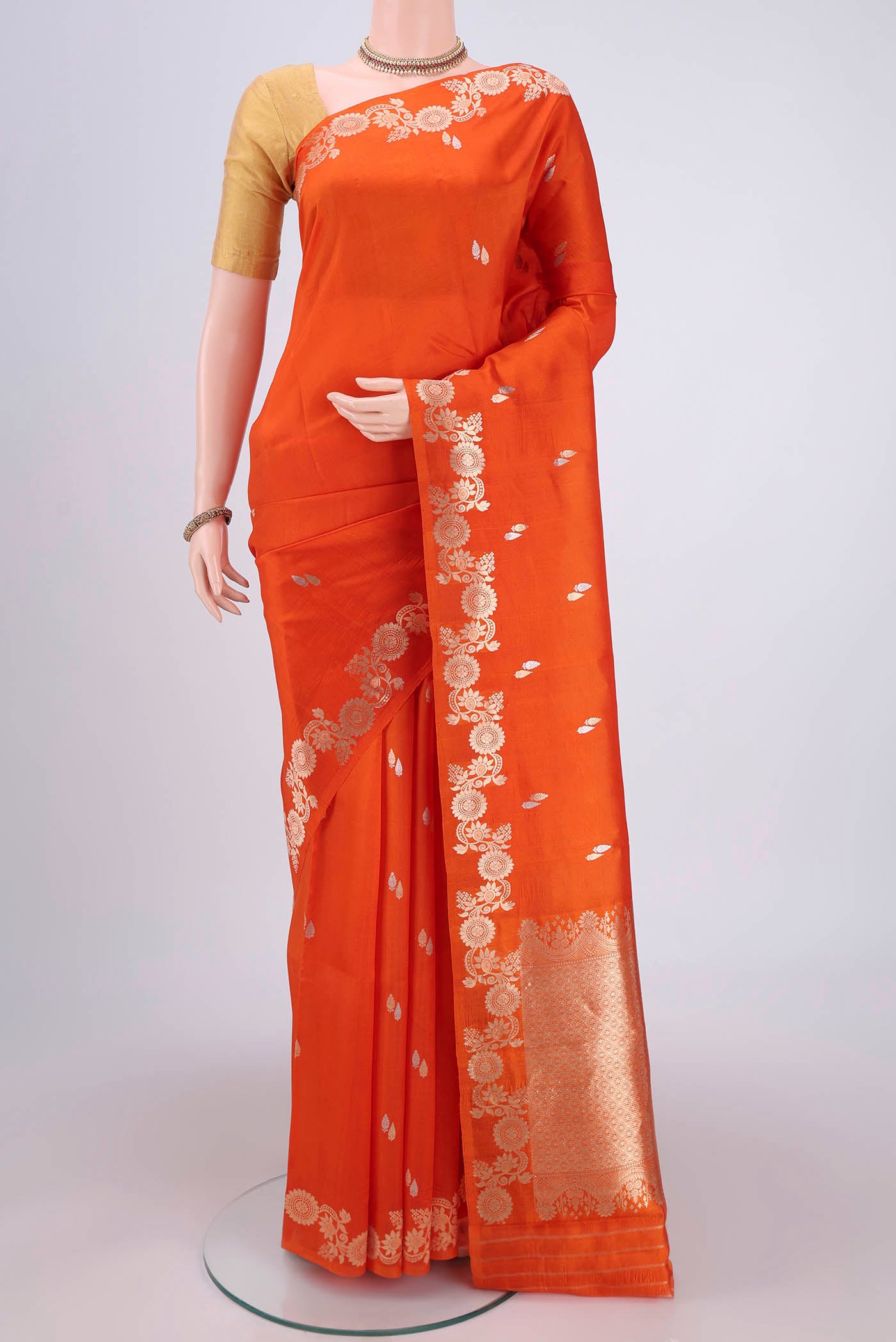 Rust Banarasi Katan Silk Saree with Zari Butta on the body and Zari Border.  displayed on a mannequin