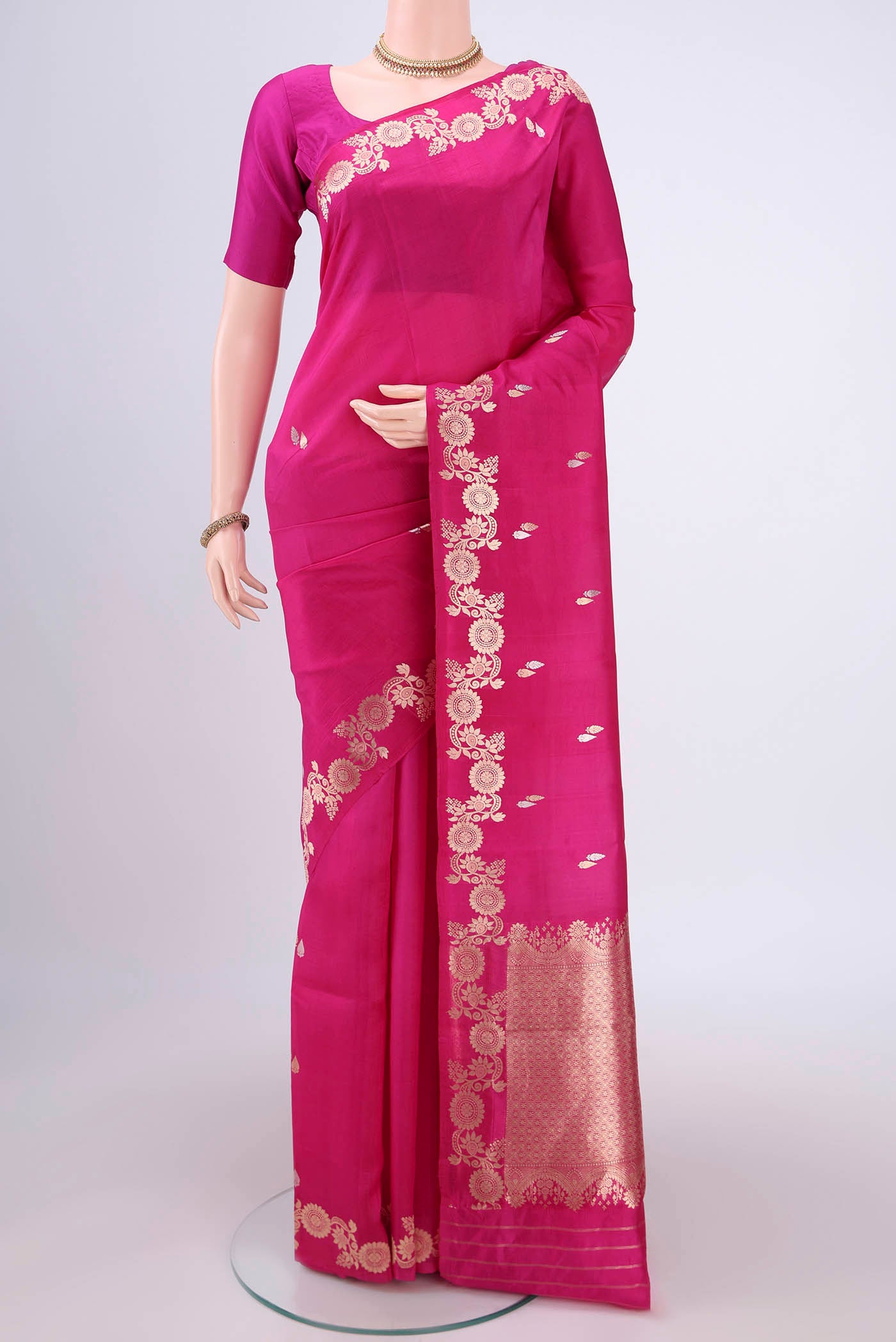 Rani Pink Banarasi Katan Silk Saree with Zari Butta on the body and Zari Border.  displayed on a mannequin