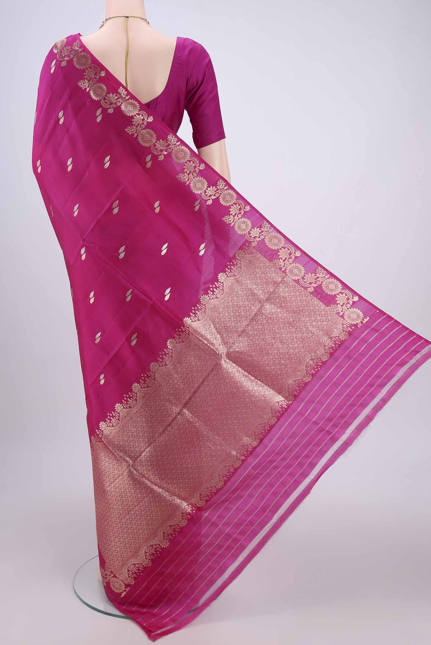 Flat view of Rani Pink Banarasi Katan Silk Saree with Zari Butta on the body and Zari Border. 