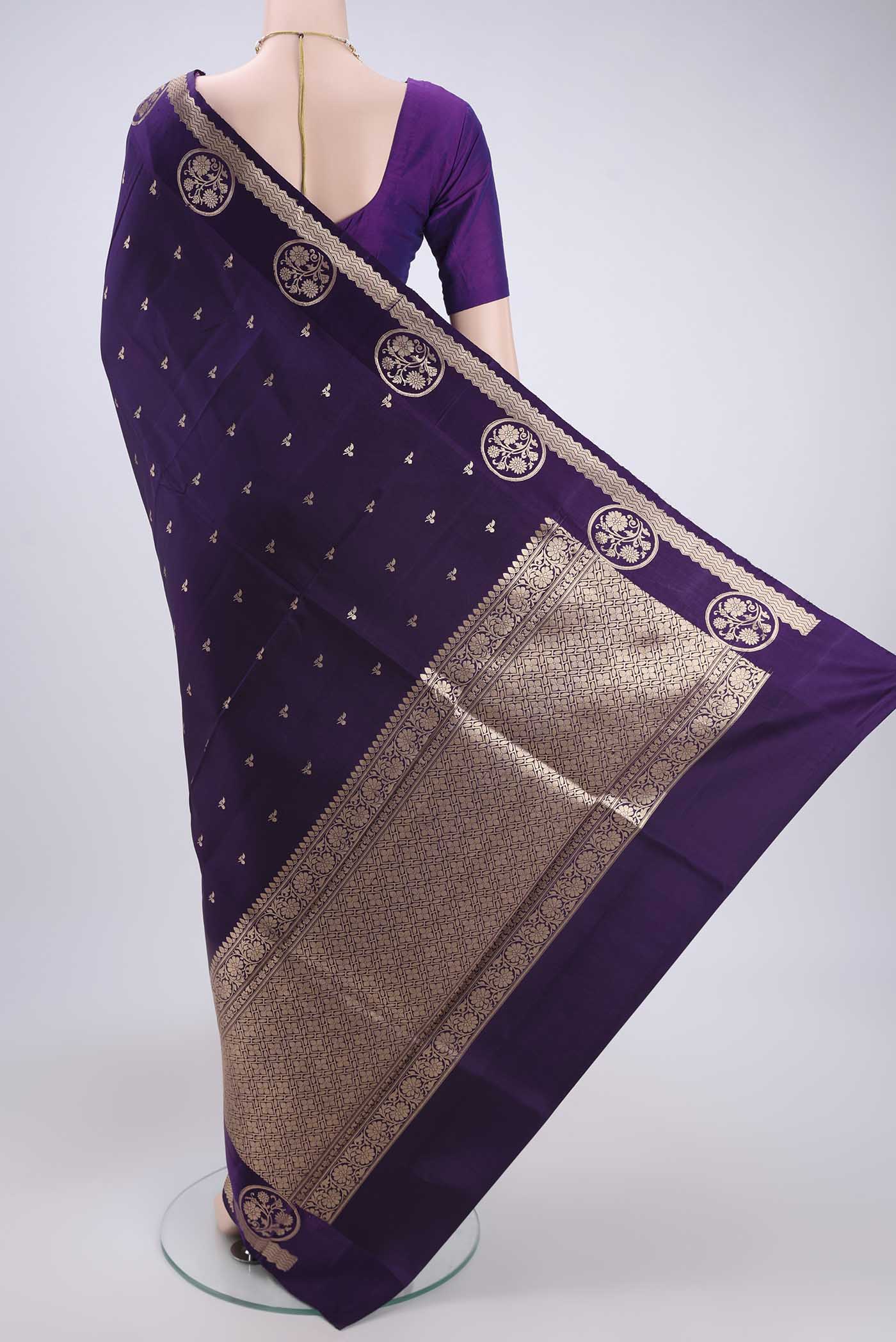 Flat view of Purple Banarasi Katan Silk Saree with Zari Butta on the body and Zari Border. 