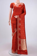 Rust Banarasi Katan Silk Saree with Zari Butta on the body and Zari Border.  displayed on a mannequin
