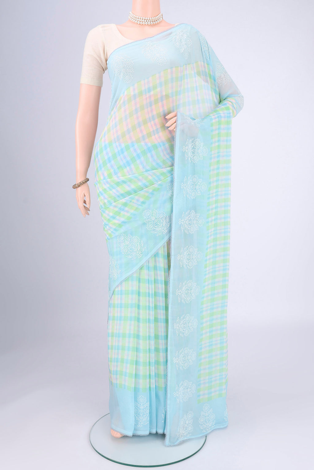 Sky Blue Mysore Chiffon Saree with Checked design on the body and Thread Border.  displayed on a mannequin