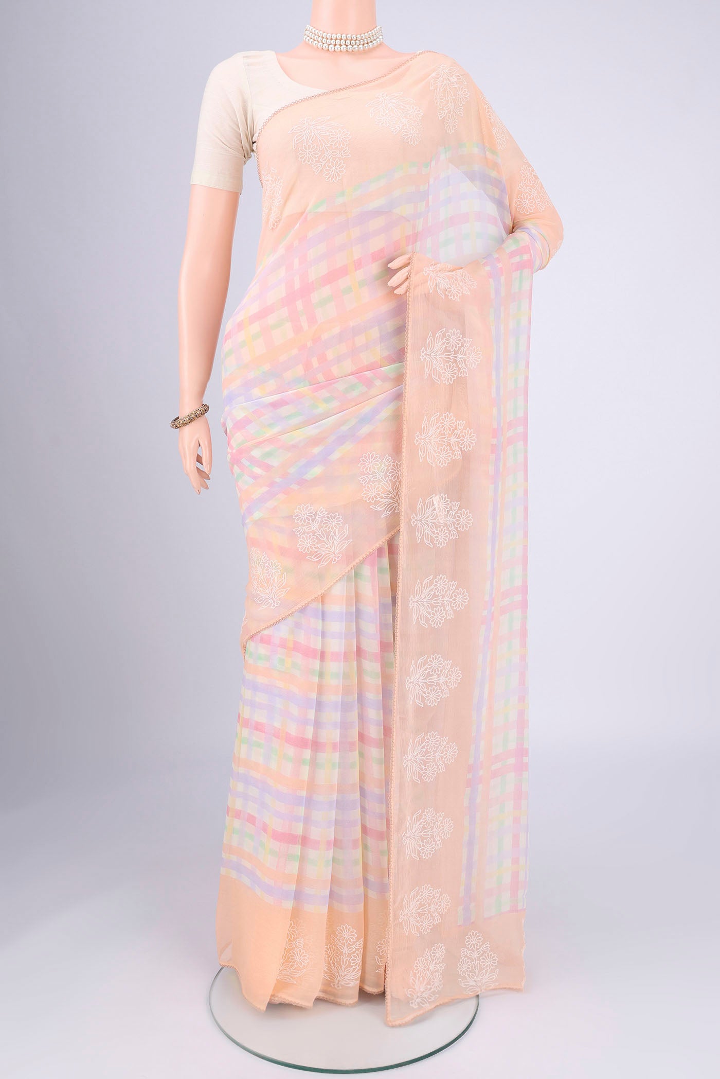 Peach Mysore Chiffon Saree with Checked design on the body and Thread Border.  displayed on a mannequin