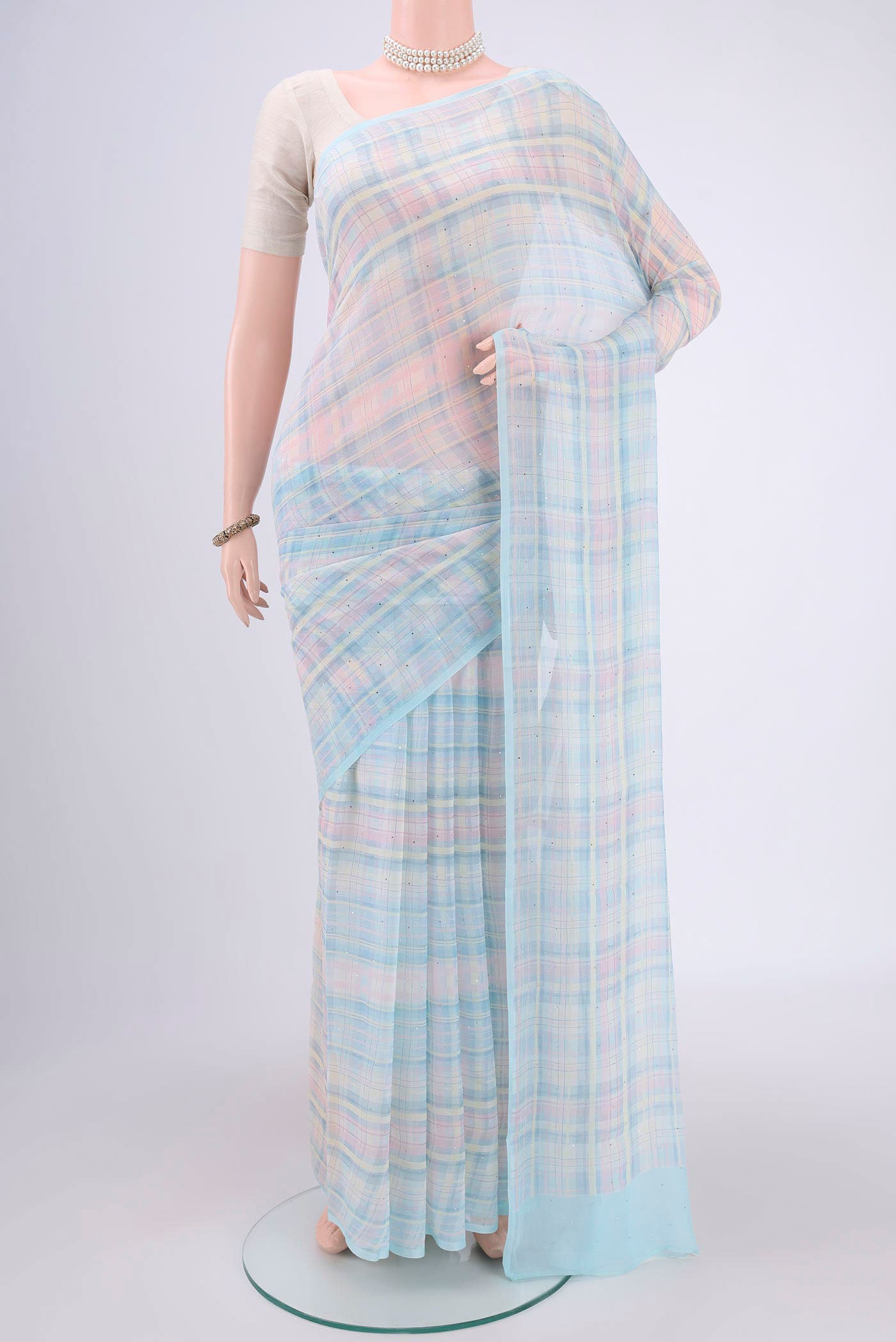Sky Blue Mysore Chiffon Saree with Checked design on the body and Without Border.  displayed on a mannequin